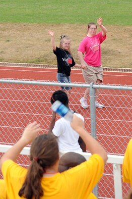 Special Olympic athletes wave to the crowd prior to the track and field portion. The event was held at Northwood High School May 7. (U.S. Air Force photo by Airman 1st Class Brittany Y. Bateman)