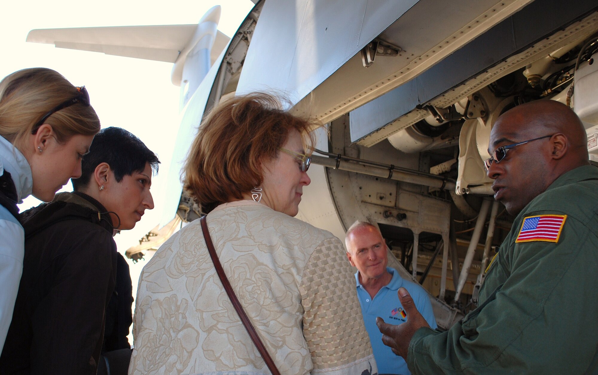 Tech. Sgt. Gerald Overton, 337th Airlift Squadron flight engineer, explains the landing gear of a C-5 to a recent Rotary International tour. Also pictured is retired Lt. Col. David Moore, who assisted coordinating and hosting the tour. Sergeant Overton and the aircrew hosted the Rotary group as part of a morning visit to Westover that also included a base history briefing and windshield tour. Base tours are held from April through December and are coordinated through public affairs. For more information on setting up tours, cliick on the "Questions" link on the Westover web site or call (413) 557-2020. (US Air Force photo/Tech. Sgt. Andrew Biscoe)