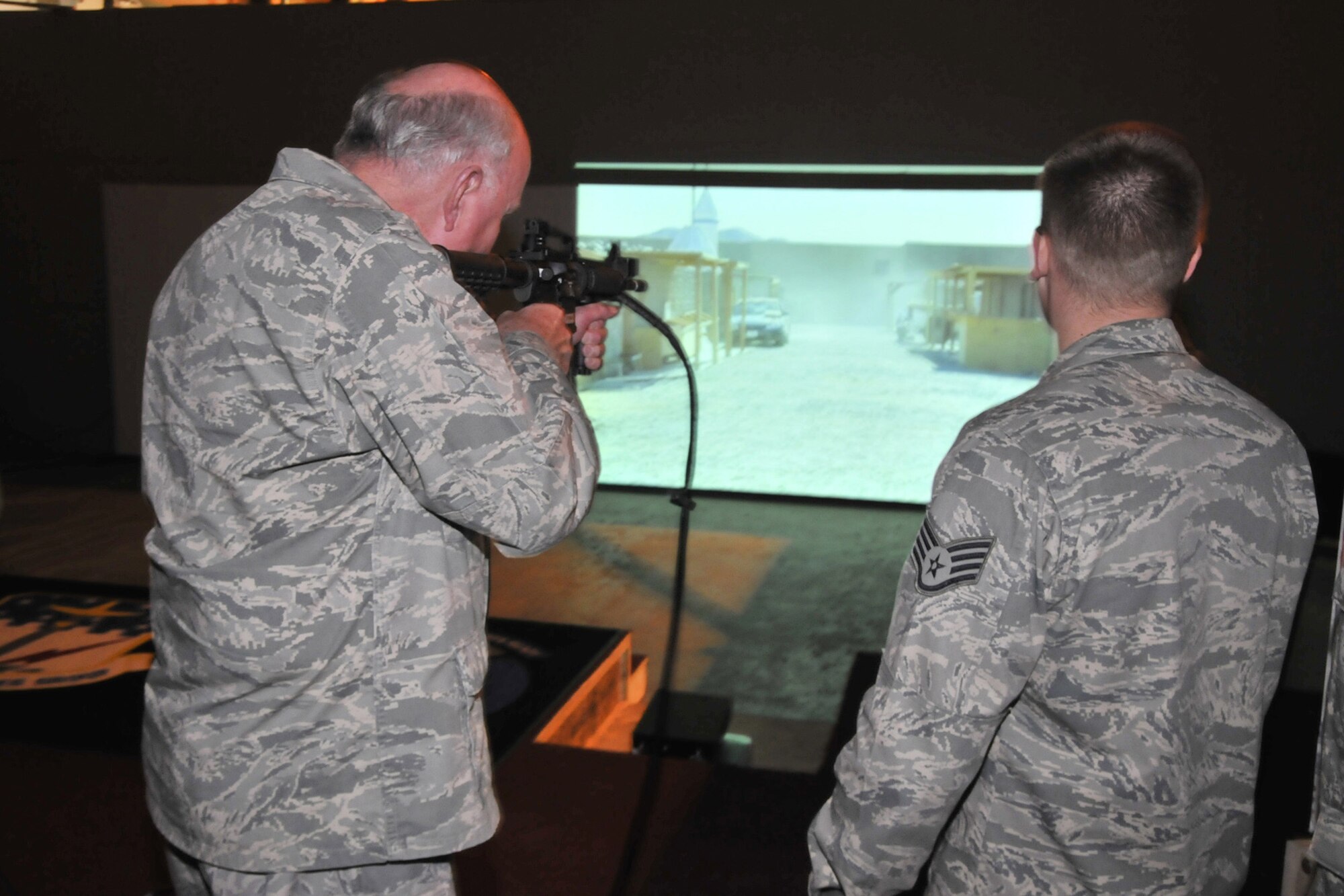 Staff Sgt. Brandon Moylan, 341st Security Support Squadron trainer, watches as Maj. Gen. Thomas Deppe, Air Force Space Command vice commander, tries out the new EST 2000 equipment during a visit to Malmstrom May 8. (U.S. Air Force photo/John Turner)