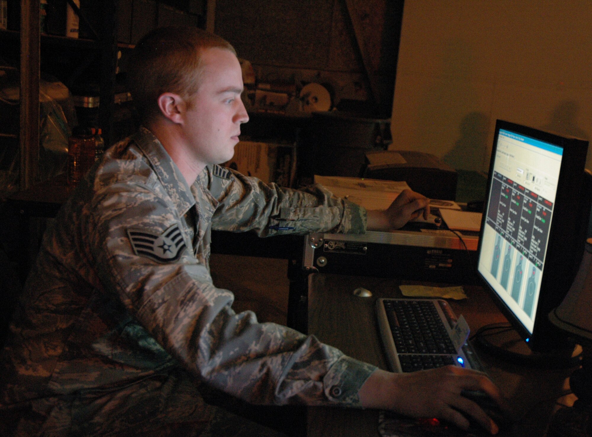 Staff Sgt. Joshua Hauser, 341st Security Support Squadron NCO in charge of security forces training, monitors an Engagement Skills Trainer control screen April 14 in Building 219. Sergeant Hauser can control many factors of EST 2000 simulations, from weapon malfunctions to weather conditions. (U.S. Air Force photo/Senior Airman Dillon White)