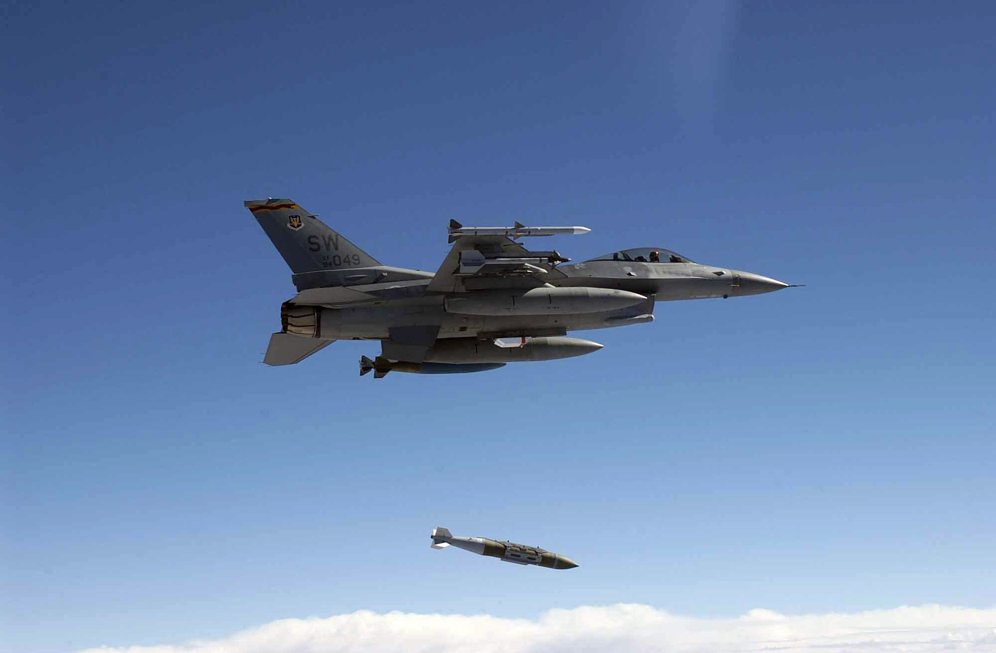 An Air Force F-16C Fighting Falcon from the 78th Fighter Squadron, Shaw Air Force Base, S.C., releases a GBU-31 1,000 pound Joint Direct Attack Munition over Eglin's land range during a test mission in 2003. (Air Force photo /Tech. Sgt. Michael Ammons)