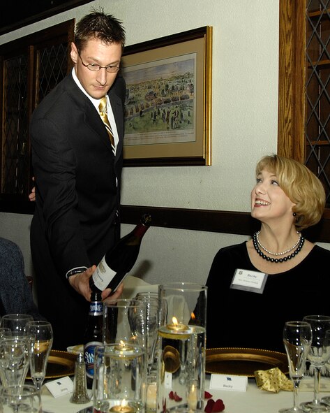 A sommelier pours a glass of wine for Becky Feehan during last January's gourmet meal at the Minuteman Club.  The club is bringing back the gourmet dinner June 13, this time with an Italian theme.  (USAF photo by Linda Labonte-Britt)