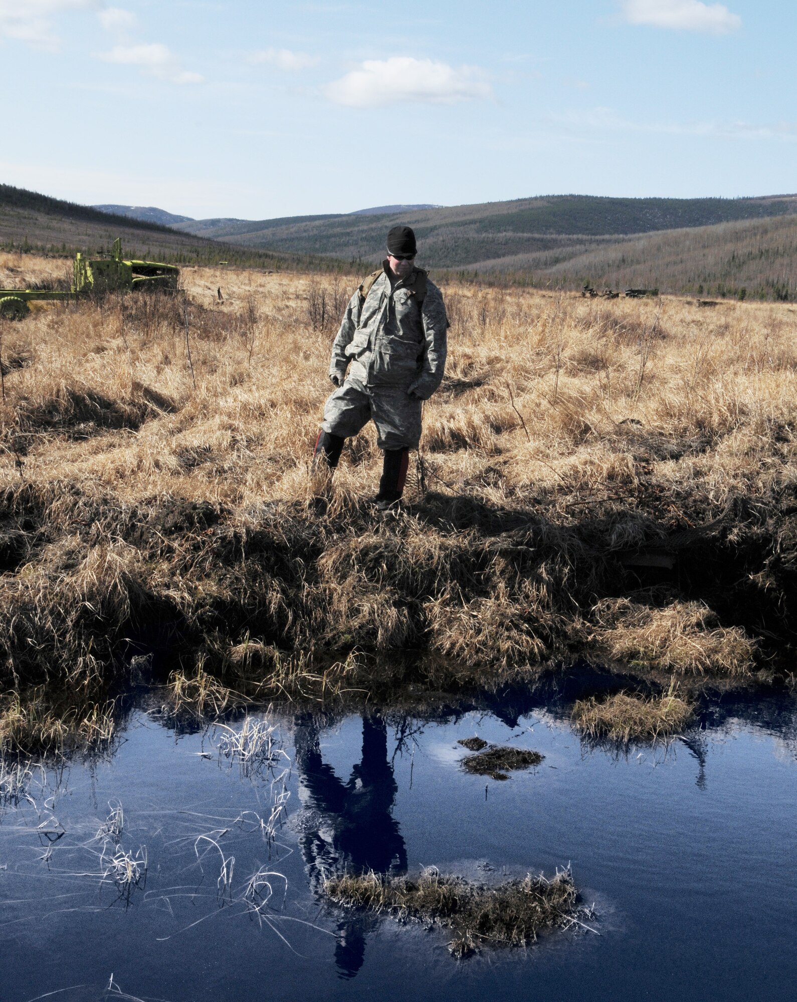 Senior Airman Matthew Leatherman surveys a pond for unexploded ordnance May 14 at the Pacific Alaskan Range Complex. The range is being searched for live munitions left over from Red Flag training operations which will later be disposed of. Airman Leatherman is with the 354th Civil Engineering Squadron Explosive Ordnance Flight. (U.S. Air Force photo/Airman 1st Class Laura Max) 
