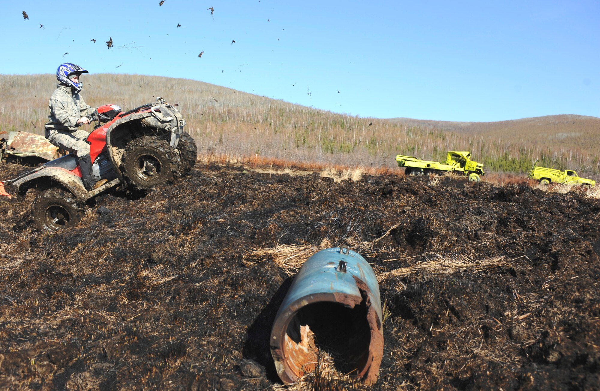 Airman 1st Class Brandon Wood uses an all-terrain vehicle to cover more ground in search of inert and live ordnance on the Yukon training area May 14 at Eielson Air Force Base, Alaska. Explosive ordnance disposal Airmen and Marines cleared 10,000 acres of land by walking within close proximity to each target while others used ATVs' to navigate the remaining terrain. Airman Wood is assigned to the 354th Civil Engineer Squadron EOD shop. (U.S. Air Force photo/Senior Airman Jonathan Snyder) 
