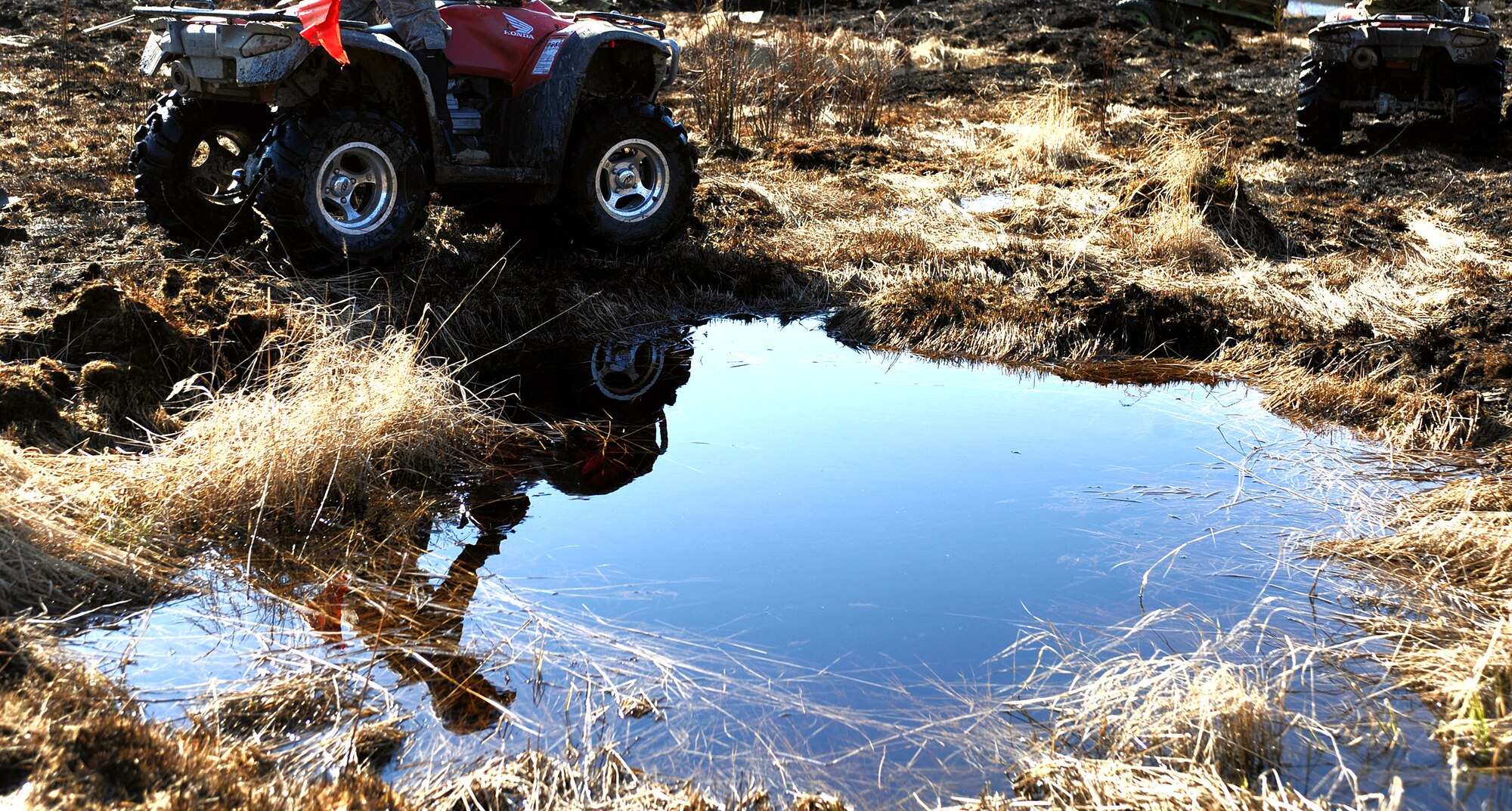 Airman 1st Class Brandon Wood uses an all-terrain vehicle to cover more ground in search of inert and live ordnance on the Yukon training area May 14 at Eielson Air Force Base, Alaska. The 354th Civil Engineer Squadron Explosive Ordnance Disposal shop mission is to remove hazardous ordnance and munitions residue from bombing and gunnery ranges, which allows target maintenance personnel to perform upkeep and reorganize target arrays. Airman Wood is assigned to the 354th CES EOD shop. (U.S. Air Force photo/Senior Airman Jonathan Snyder) 
