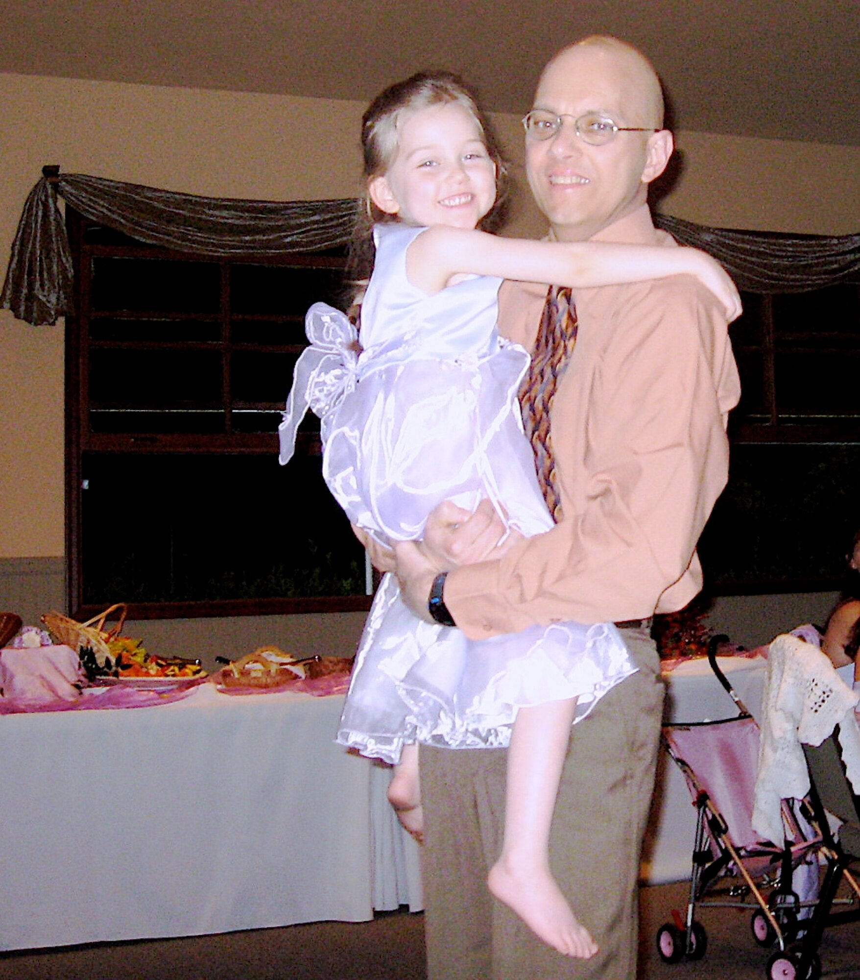 Master Sgt. Mike Sanders, pictured here with daughter Jenna, four months after his final radiation treatment while fighting cancer.  Sergeant Sanders was still extremely fatigued when this photo was taken at a friend's wedding, but his daughter wanted to dance and he wasn't going to disappoint her. (Photo courtesy Master Sgt. Mike Sanders) 