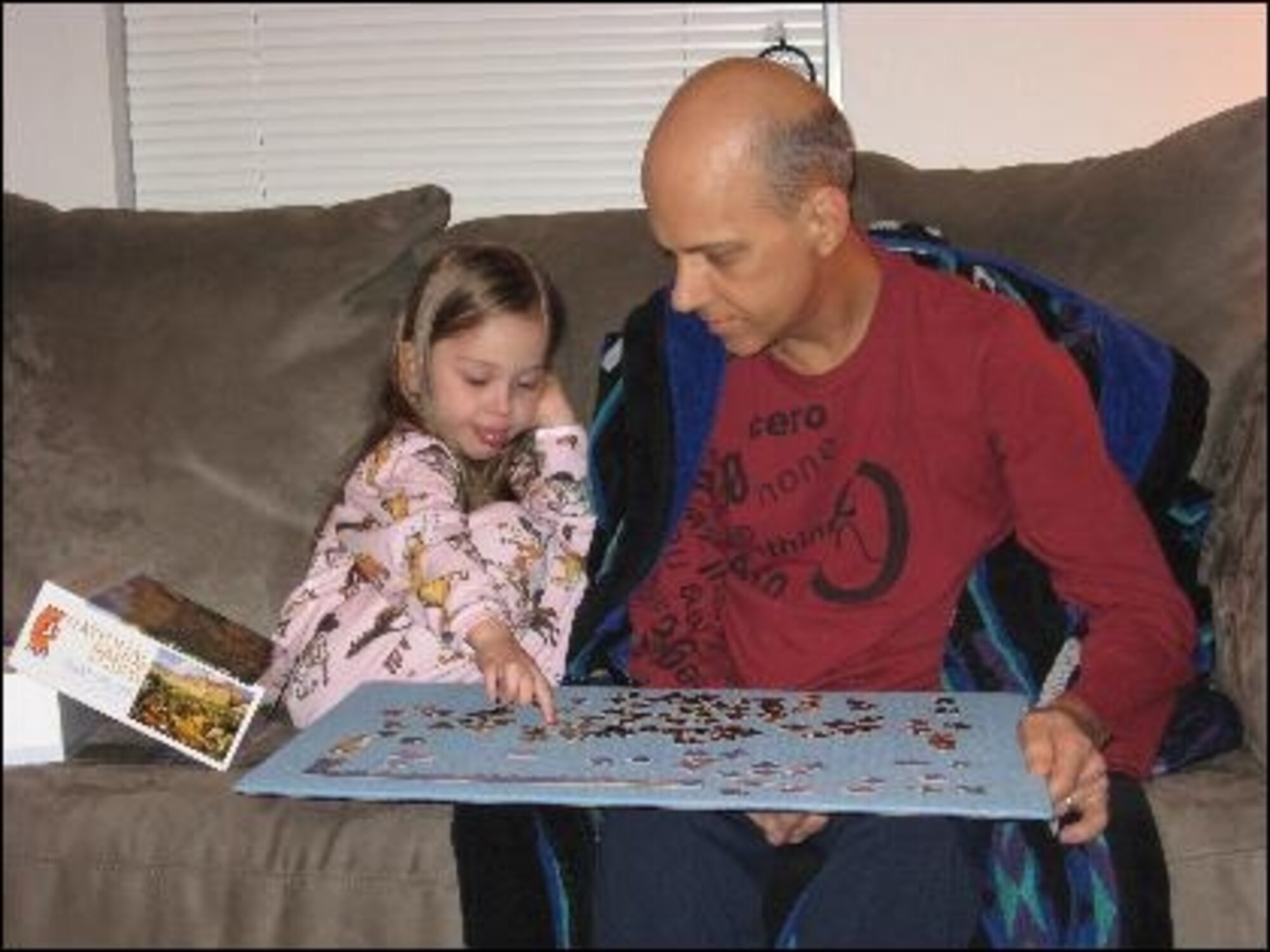 Master Sgt. Mike Sanders, pictured here with daughter, Jenna, during recovery from throat cancer in 2008. In this familiy photo Jenna is helping Sergeant Sanders stay focused with getting better by keeping him occupied and thinking positively. (Photo courtesy Master Sgt. Mike Sanders) 