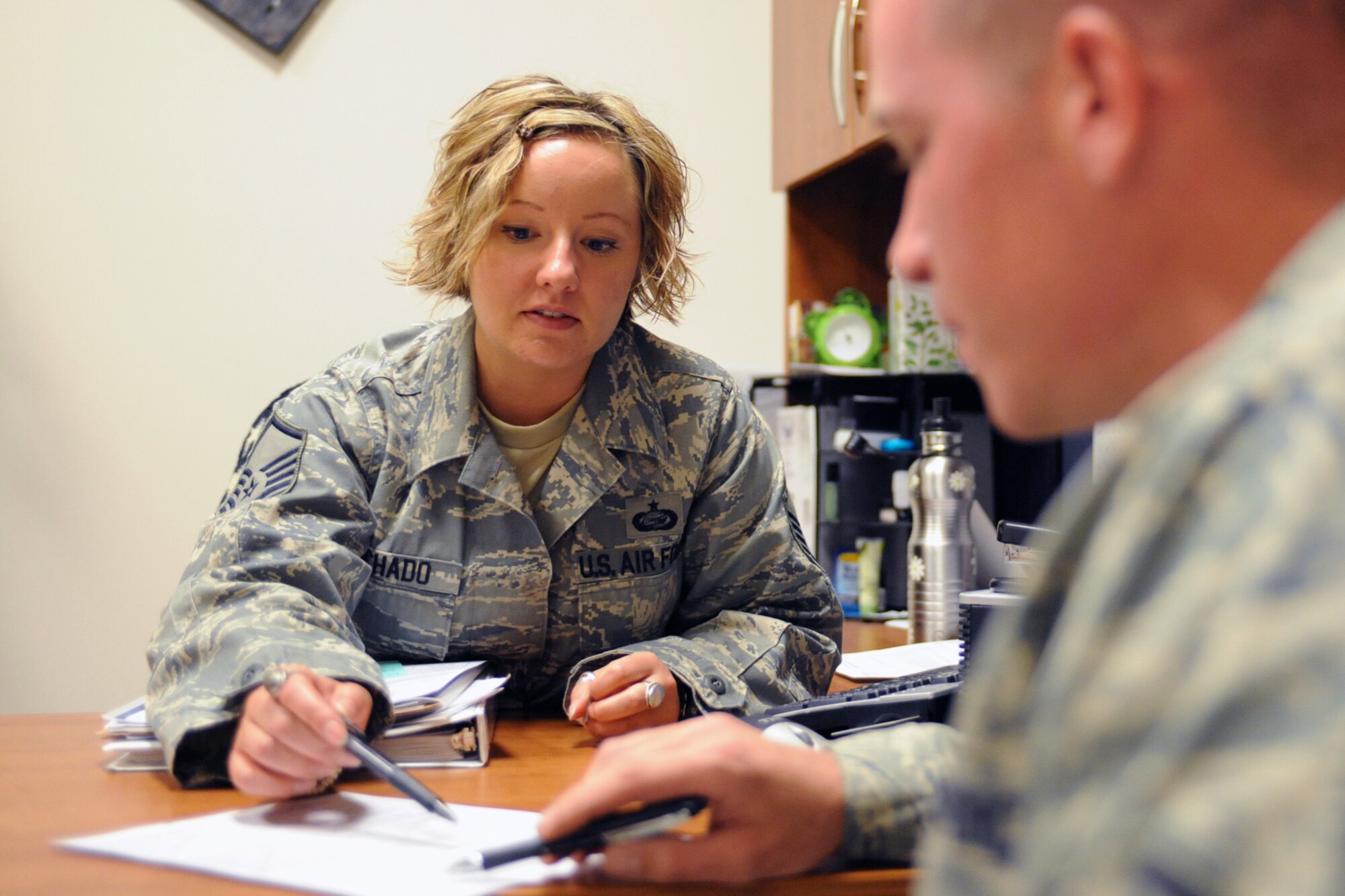 Master Sgt. Karine Machado, the 419th Fighter Wing’s career advisor, visits with Staff Sgt. James Bluhm about the Air Force re-enlistment bonuses. The program offers re-enlistment bonuses for those who agree to re-enlist in AFSCs that the Air Force considers "critically short." (U.S. Air Force photo/Staff Sgt. Kyle Brasier)