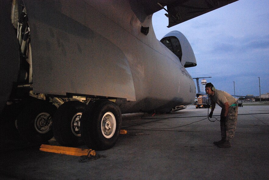 An Alamo Wing C-5A Galaxy cargo aircraft is being photographed for the cover of Airman Magazine against a Texas sunrise on the flightline of Lackland AFB. The 433rd Airlift Wing's Maintenance Squadron readied the aircraft in the pre-dawn darkness. (U.S. Air Force Photo/Airman Brian McGloin)