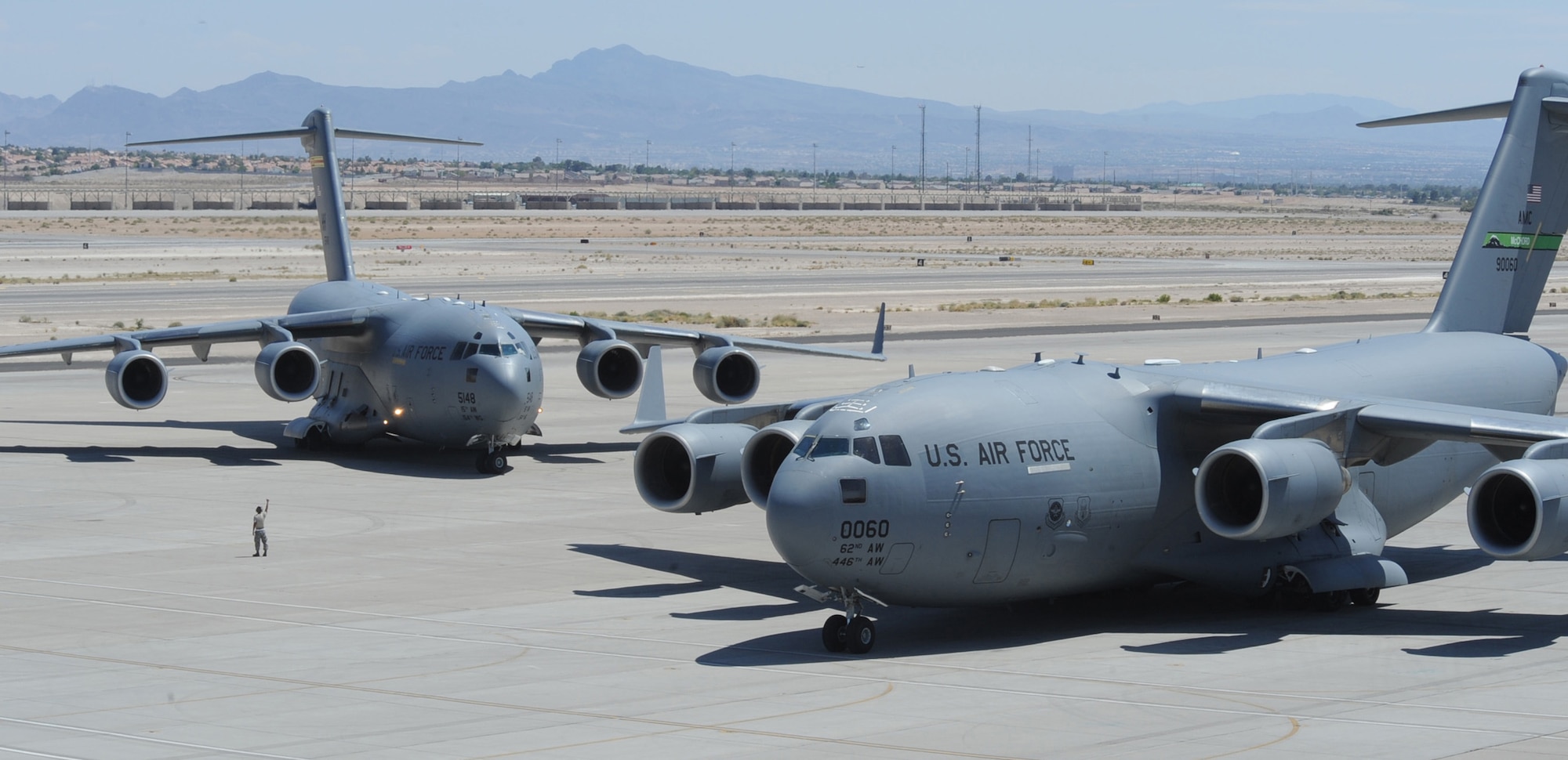 C-17 Globemaster IIIs, like the ones shown here at Nellis Air Force Base, Nev., provide intra-theater heavy airlift, helping to sustain operations throughout Afghanistan, Iraq and the Horn of Africa.  (U.S. Air Force photo/Airman 1st Class Stephanie Rubi)