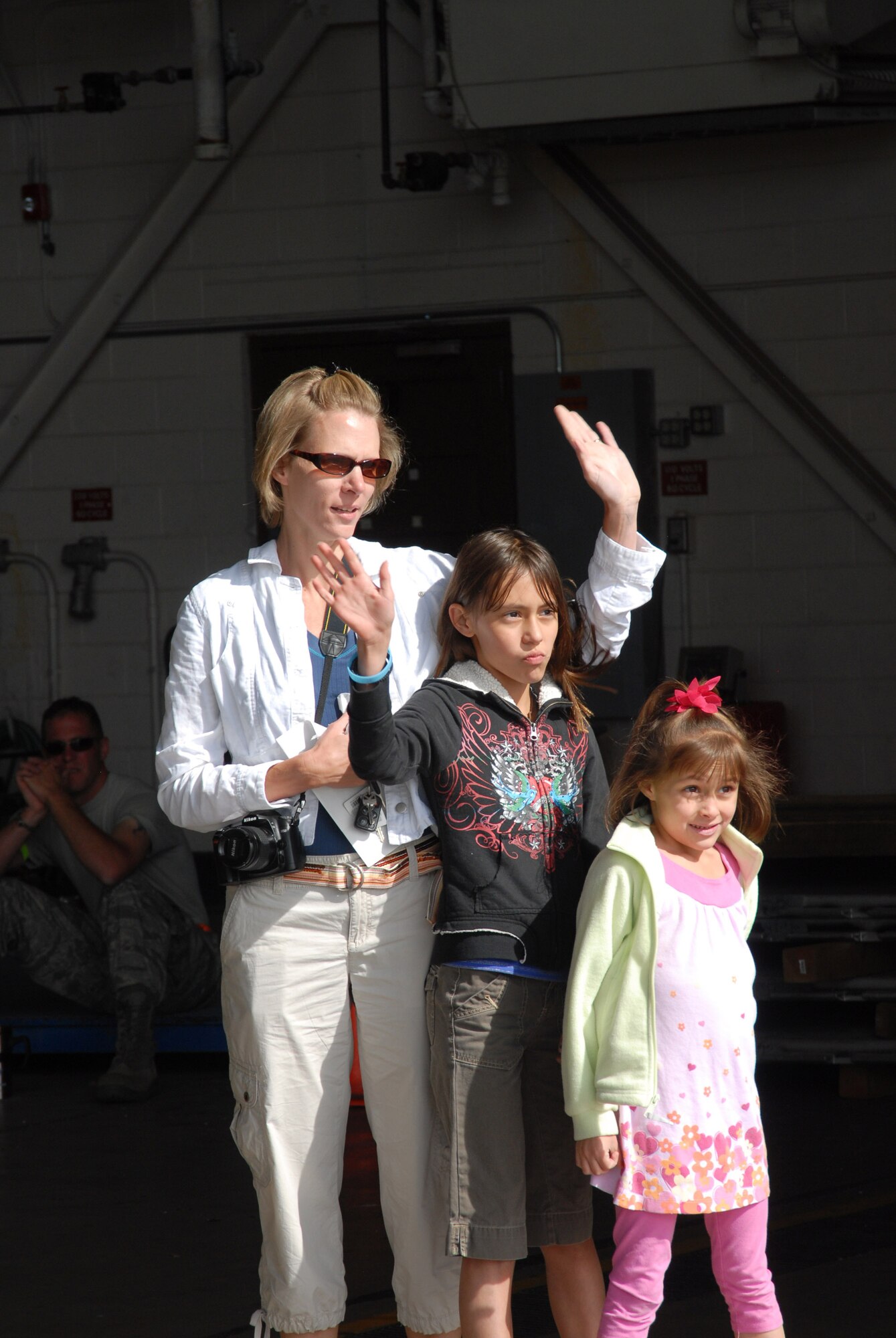 Stefanie Solis and her daughters, Shelby and Skylar, wave goodbye to their dad, Technical Sergeant Andre Solis, as his plane takes off from Buckley.  He and approximately 30 members from the 140th Security Forces Squadron, 140th Wing, Colorado Air National Guard, will deploy for six months in support of Operation Iraqi Freedom (OIF).  This is the seventh deployment for this unit in support of OIF.