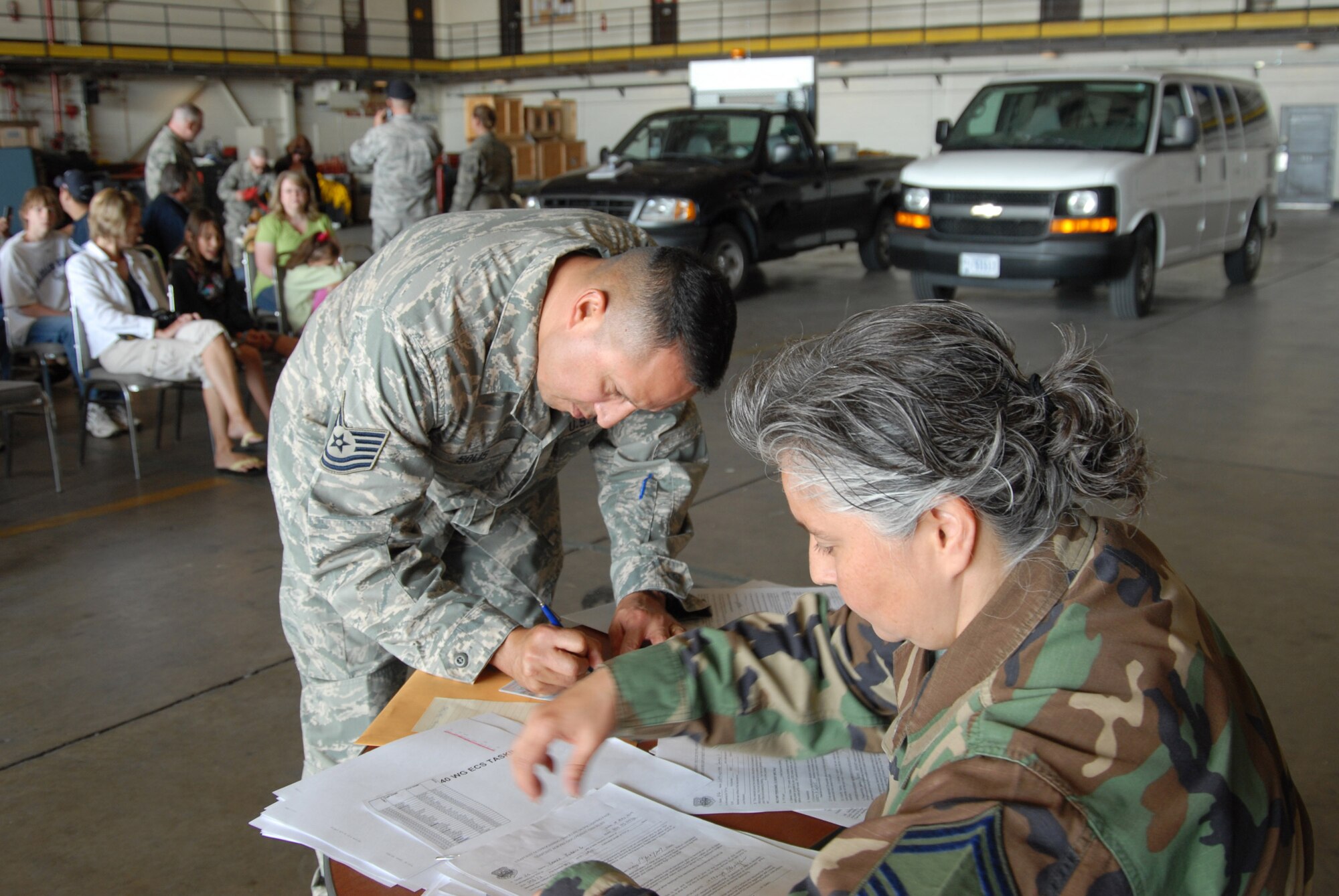 Technical Sergeant Andre Solis fills out paperwork before loading the aircraft and departing Buckley Air Force Base.  More than 30 members of the 140th Security Forces Squadron will deploy for six months, putting their civilian careers on hold.