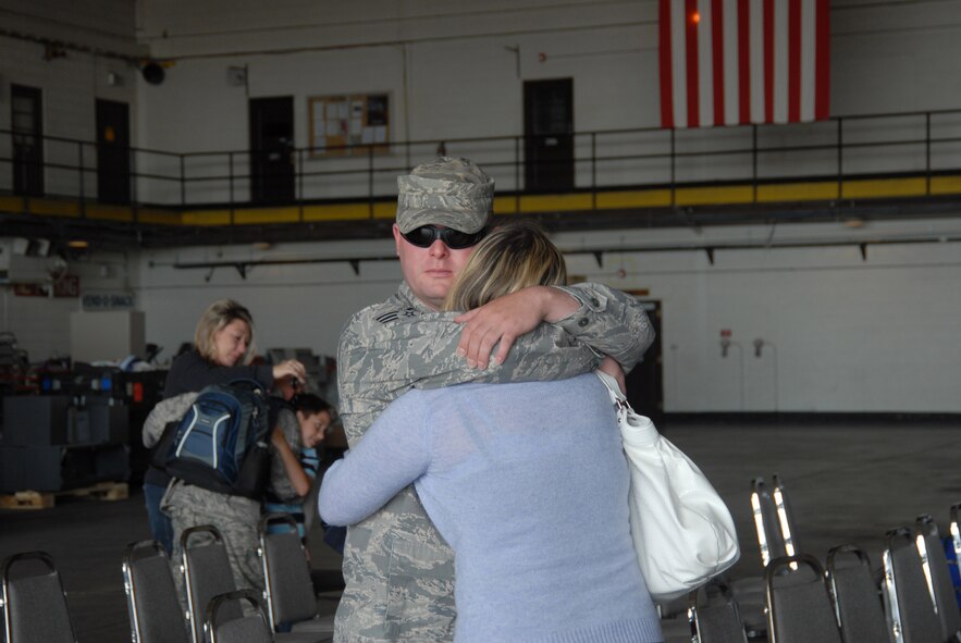 Senior Airmen Daniel Schultz, of Denver Colorado, hugs his girlfriend, Jennifer Thomson, before departing Buckley Air Force Base this morning.  Daniel will deploy for six months in support of Operation Iraqi Freedom.  