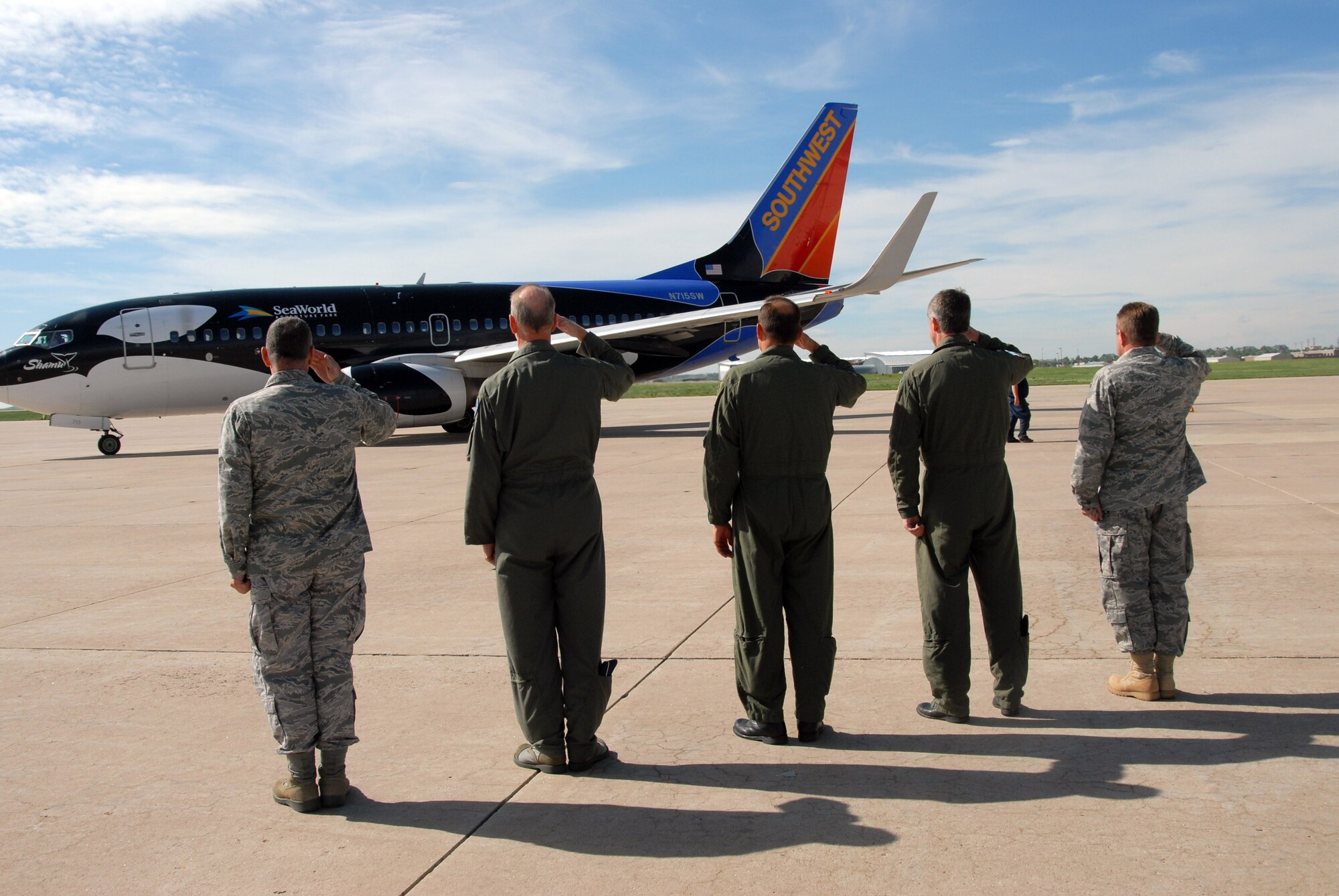 Senior Leadership from the Colorado National Guard salute the aircraft as it taxiis for departure.  More than 30 members of the 140th Security Forces Squadron, 140th Wing, Colorado Air National Guard, will deploy for six months. The unit will perform security for personnel and assets while in the U.S. Central Command Area of Operations.