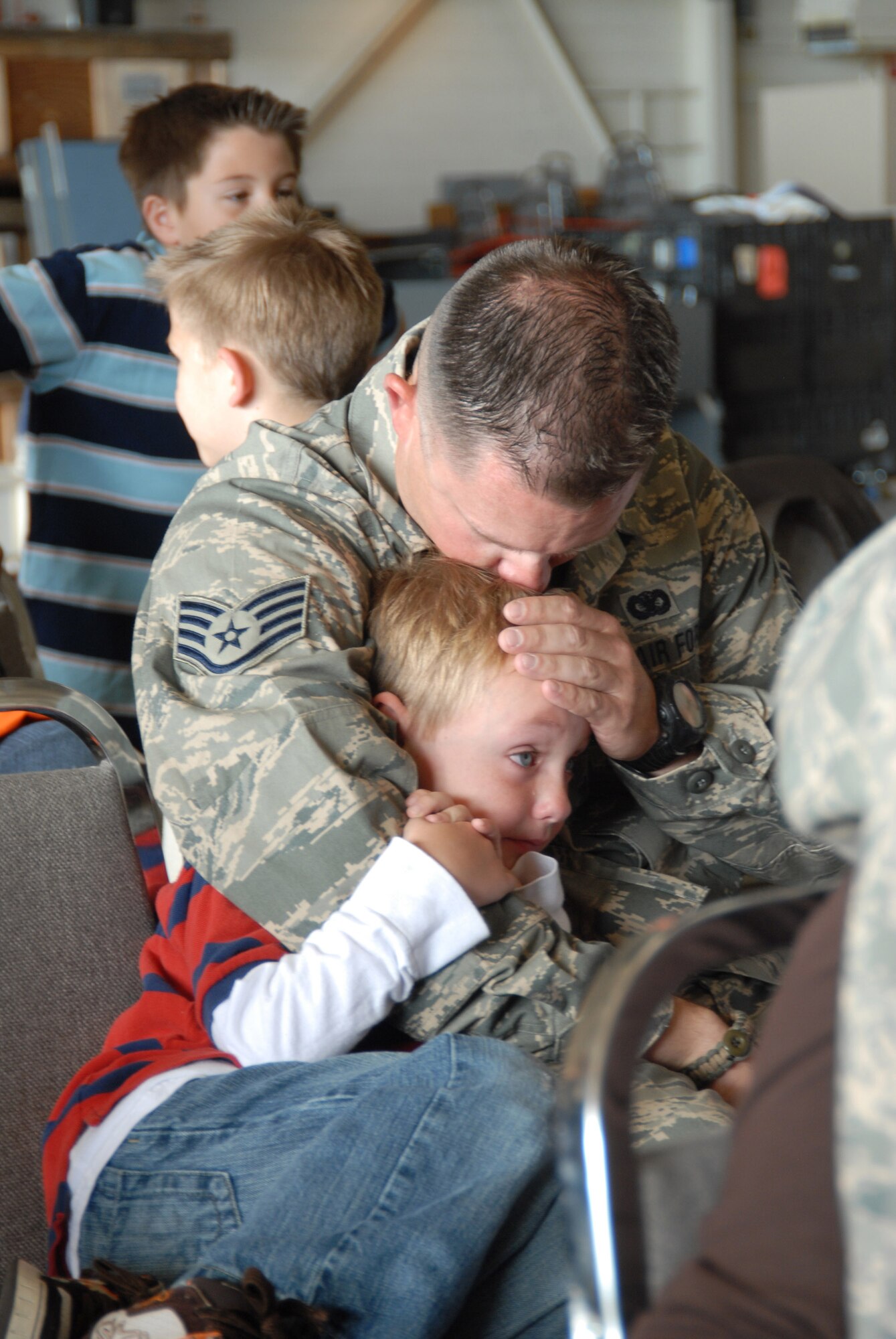 Staff Sergeant Jason Tarrett kisses his son, Tucker, before departing Buckley Air Force Base this morning.  Jason is a member of the 140th Security Forces Squadron, !40th Wing, Colorado Air National Guard.  More than 30 members of his unit will deploy for six months in support of Operation Iraqi Freedom.