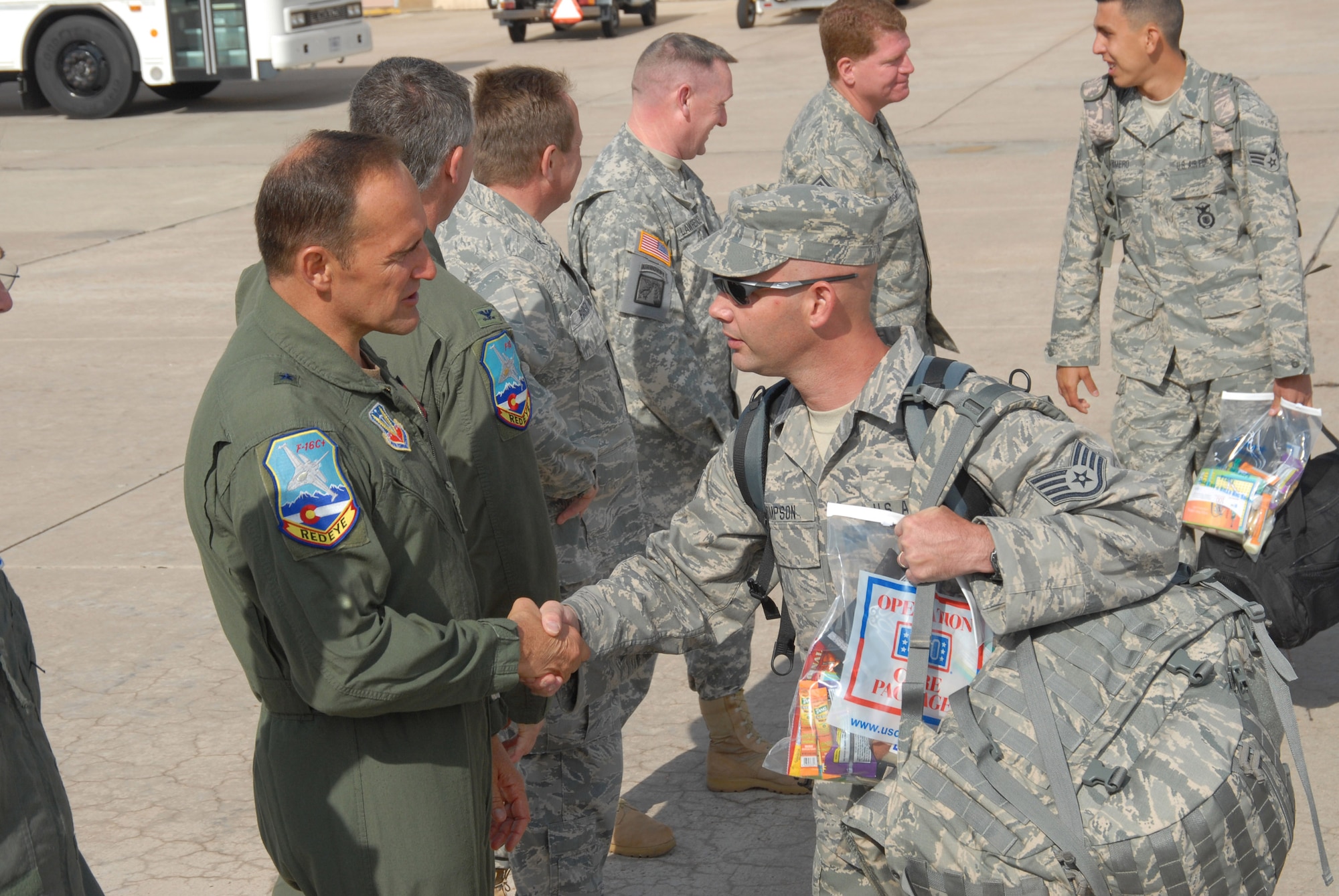 Staff Sergeant Michael Thompson, 140th Security Forces Squadron, says goodbye to Brigadier General Trulan Eyre, Commander of the 140th Wing, before loading the plane.  The unit will provide force protection duties while deployed for six months to the U.S. Central Command Area of Operations. This is the 7th deployment for this unit in support of Operation Iraqi Freedom.
