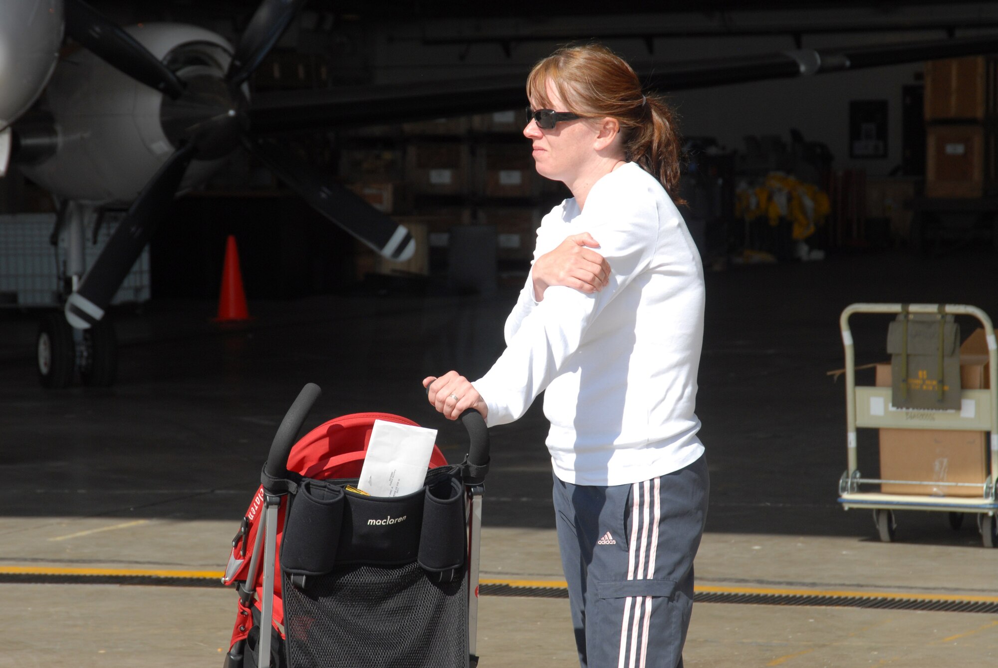 Jeri Jones looks on as her husband, Staff Sergeant Rueben Gomez, loads the aircraft.  More than fifteen members of the 140th Security Forces Squadron, 140th Wing, Colorado Air National Guard, left Buckley Air Force Base this morning.
