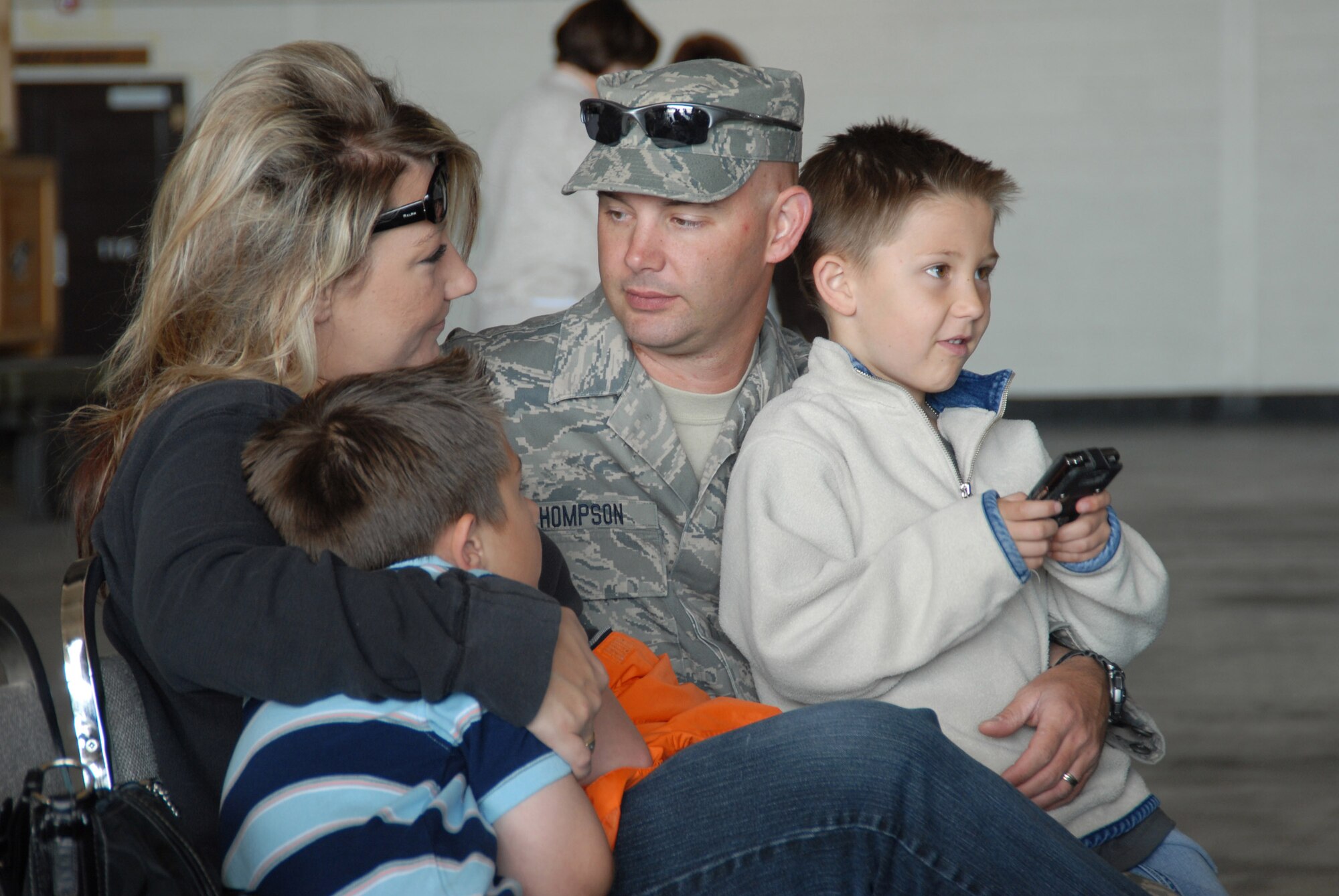 Staff Sergeant Michael Thomspon, of Aurora, Colorado, talks to his wife, Jerica, with children Trenton (left) and Tarrent.  Members of the 140th Security Forces Squadron, Colorado Air National Guard, departed Buckley Air Force Base this morning for a six-month deployment.  The members will perform personnel and asset security operations in the U.S Central Command Area of Operations.