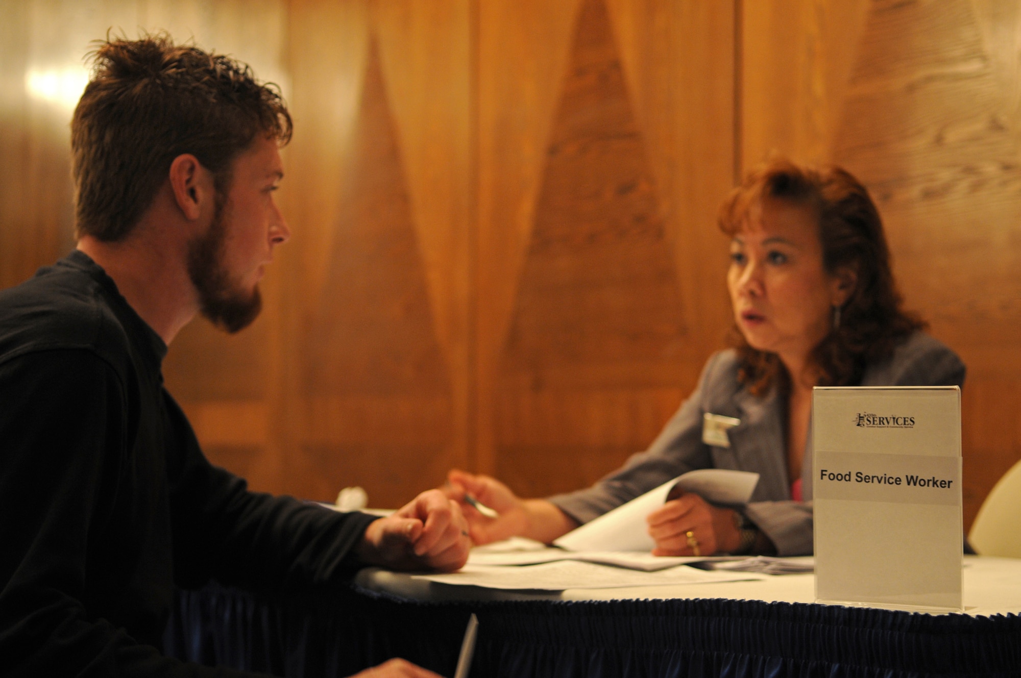 Charlie Knoll, a military dependant, gets interviewed by Maria Wells, 435th Services Human Resources director, at the 435th Services Job Fair held on Ramstein Air Base, Germany, May 18, 2009. The 435th SVS plans to employ more than 650 civilians, dependents and off-duty military hires for the upcoming KMCC. (U.S. Air Force photo by Airman 1st Class Grovert Fuentes-Contreras)