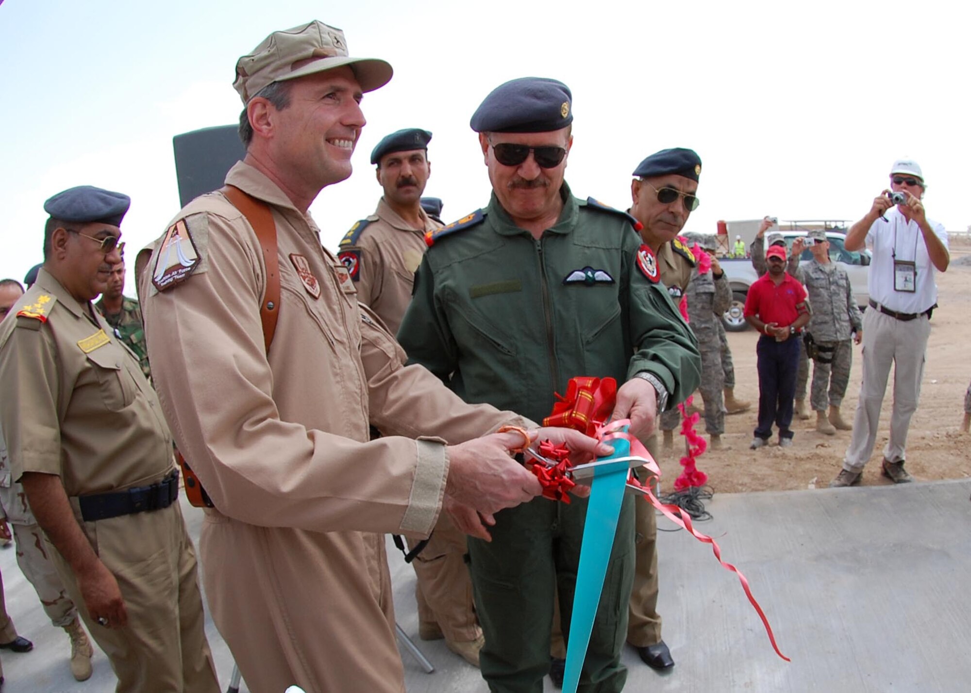 Brig. Gen. Robert Kane, left, 321st Air Expeditionary Wing and CAFTT commander, and Iraqi Air Force Commander, Staff Lieutenant General Anwar, cut the ribbon on the new munitions storage area at Camp Taji, Iraq May 13, 2009. The munitions storage area, was modeled after the munitions storage facilities used by the U.S. Air Force, and consist of three bays designed to conduct maintenance on rockets, chaff and/or flares and munitions. The facility was one of three new buildings dedicated to the Iraqi air force here. (U.S. Air Force photo by Staff Sgt. Tim Beckham)