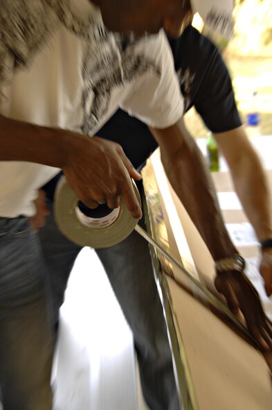 Build-a-boat competitor, Staff Sgt. Martin Wallace, 39th Contracting Squadron, seals a seam in his team’s home-made boat, Thursday, May 21, 2009. Teams were given four pieces of cardboard and two rolls of duct tape to build the best sea-worthy boat possible before the event. Five teams competed and prizes were awarded for fasted boat, best decoration and first boat to sink. The 39th Civil Engineer Squadron team finished in first place and was awarded a $100 gift certificate to be spent at a services location on base. (U.S. Air Force photo/Senior Airman Benjamin Wilson)