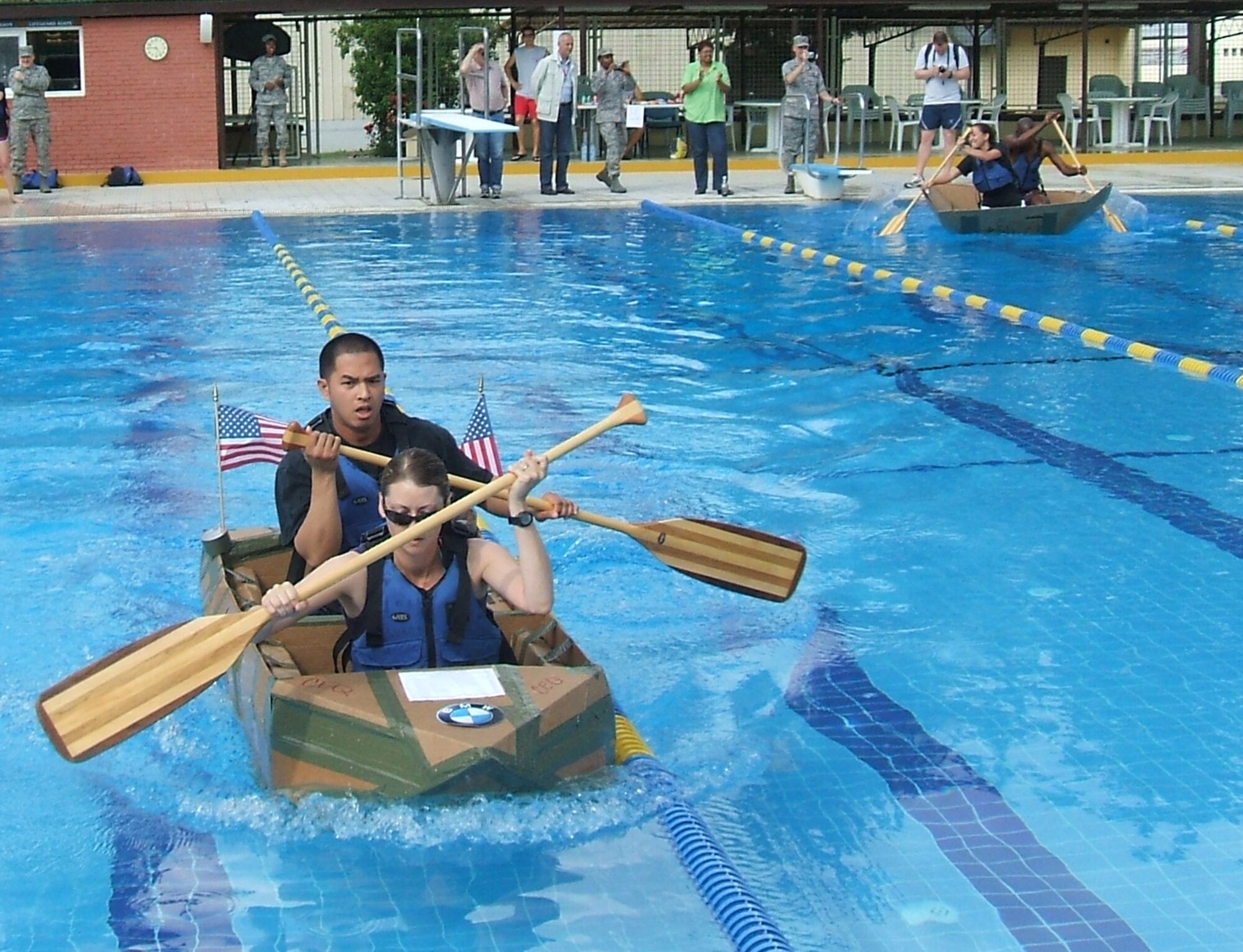 Capt. Rebecca MacIsaac and Tech. Sgt. Arnold Sarmiento, both from the 39th Civil Engineer Squadron, paddle their home-made boat to the finish line during the first heat of the Incirlik build-a-boat competition, Friday, May 22, 2009. The 39 CES team finished in first place and was awarded a $100 gift certificate to be spent at a services location on base. Teams were given four pieces of cardboard and two rolls of duct tape to build the best sea-worthy boat possible before the event. Five teams competed and prizes were awarded for fasted boat, best decoration and first boat to sink. (courtesy photo)