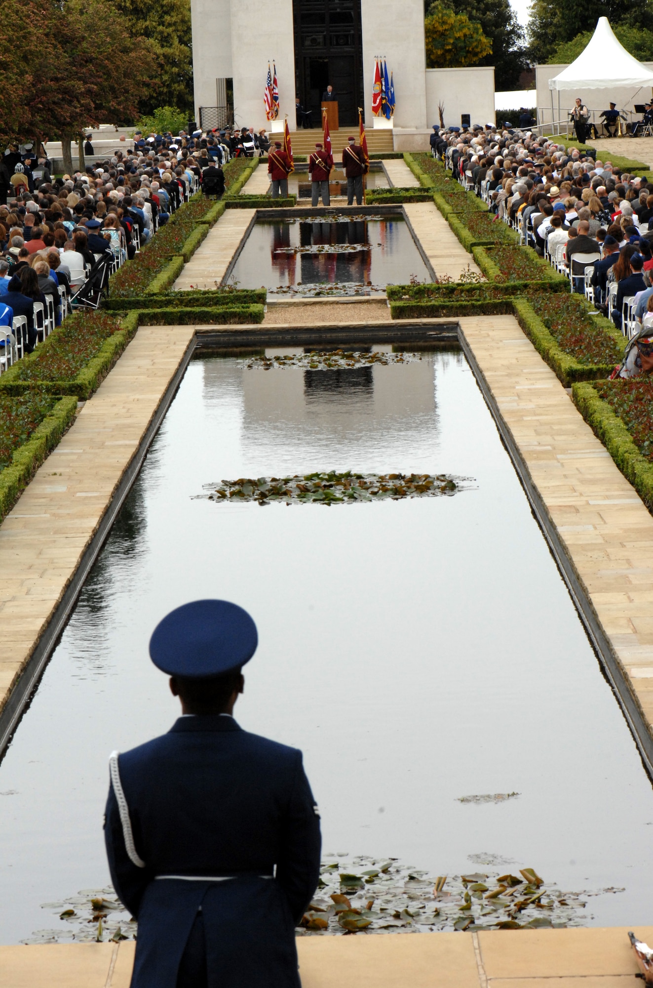 RAF MILDENHALL, England – Hundreds of military members and their families gathered around the reflective pools at Madingley Memorial Cemetery to honor the American veterans buried there May 25, 2009.  A ceremony is held at the cemetery every year in observance of Memorial Day.  (U.S. Air Force file photo)