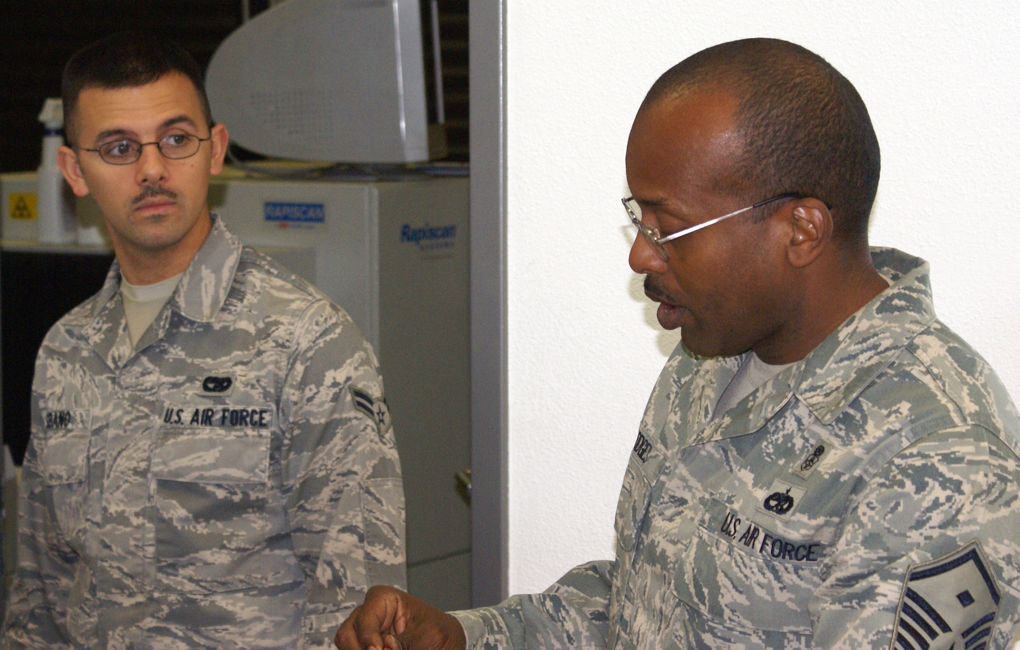 SPANGDAHLEM AIR BASE, Germany ---- Master Sgt. Alfred Hodges, 726th Air Mobility Squadron first sergeant, talks Airman 1st Class Nicholas Sbano, 726th AMS, with about his duties at the passenger terminal. First sergeant duty provides the opportunity to help other all Airmen, officers, enlisted and civilian co-workers. (U.S. Air Force photo by Senior Master Sgt. Dennis Wingett)