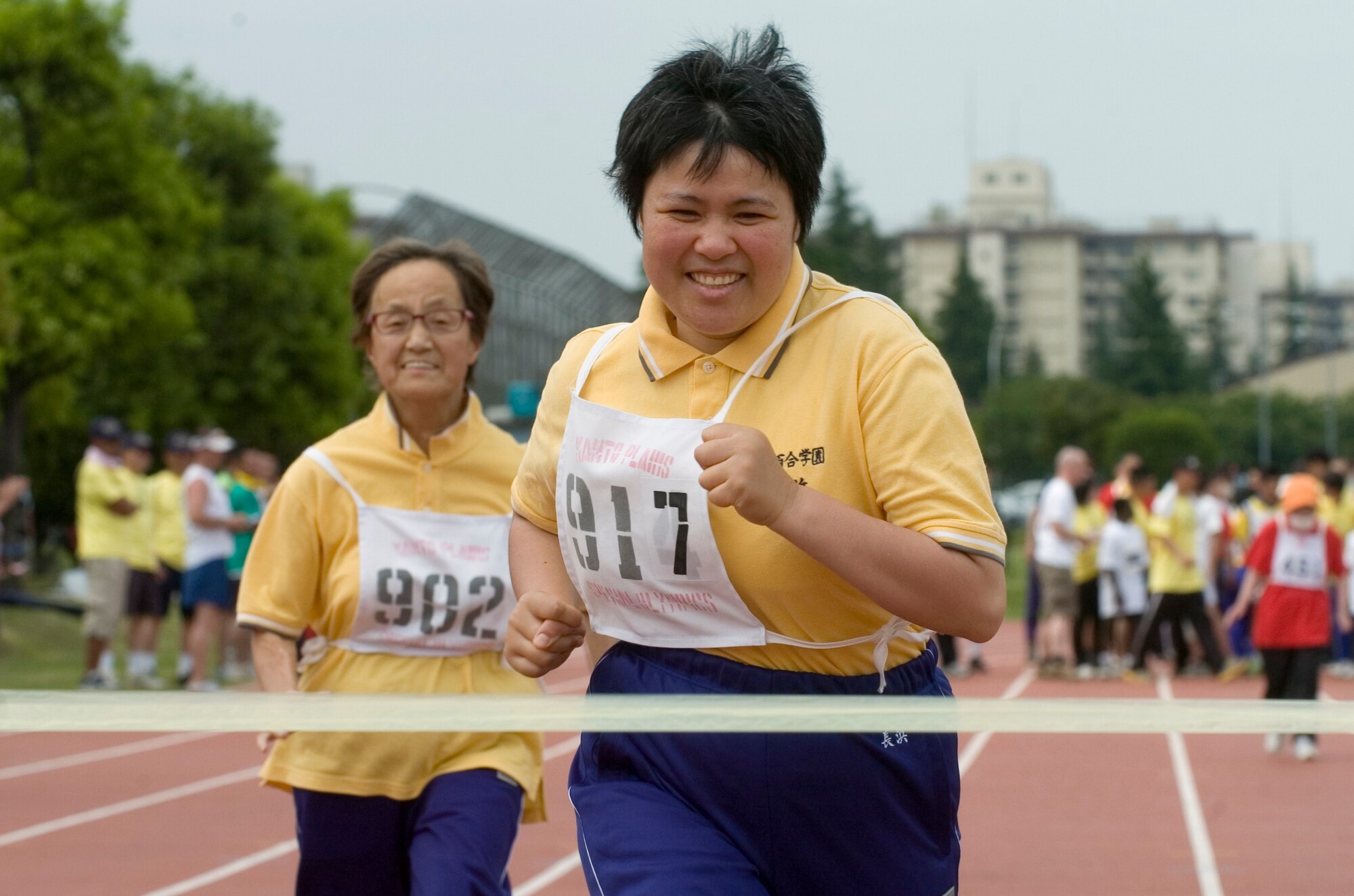 YOKOTA AIR BASE, Japan -- Miyuki Nagahama (right) and Naoko Asai from the Shirayuri Gakuen School in Tachikawa finish first and second in their heat of the 50-meter dash May 23 during the 30th Annual Kanto Plain Special Olympics at Yokota's Bonk Field. More than 100 athletes from eight local schools competed in events ranging from the standing long jump and 50-meter dash to bowling and swimming. More than 300 volunteers from U.S. military installations and members of the Japanese Self Defense Forces also took part in the event. (U.S. Air Force photo/Master Sgt. Matt Summers)