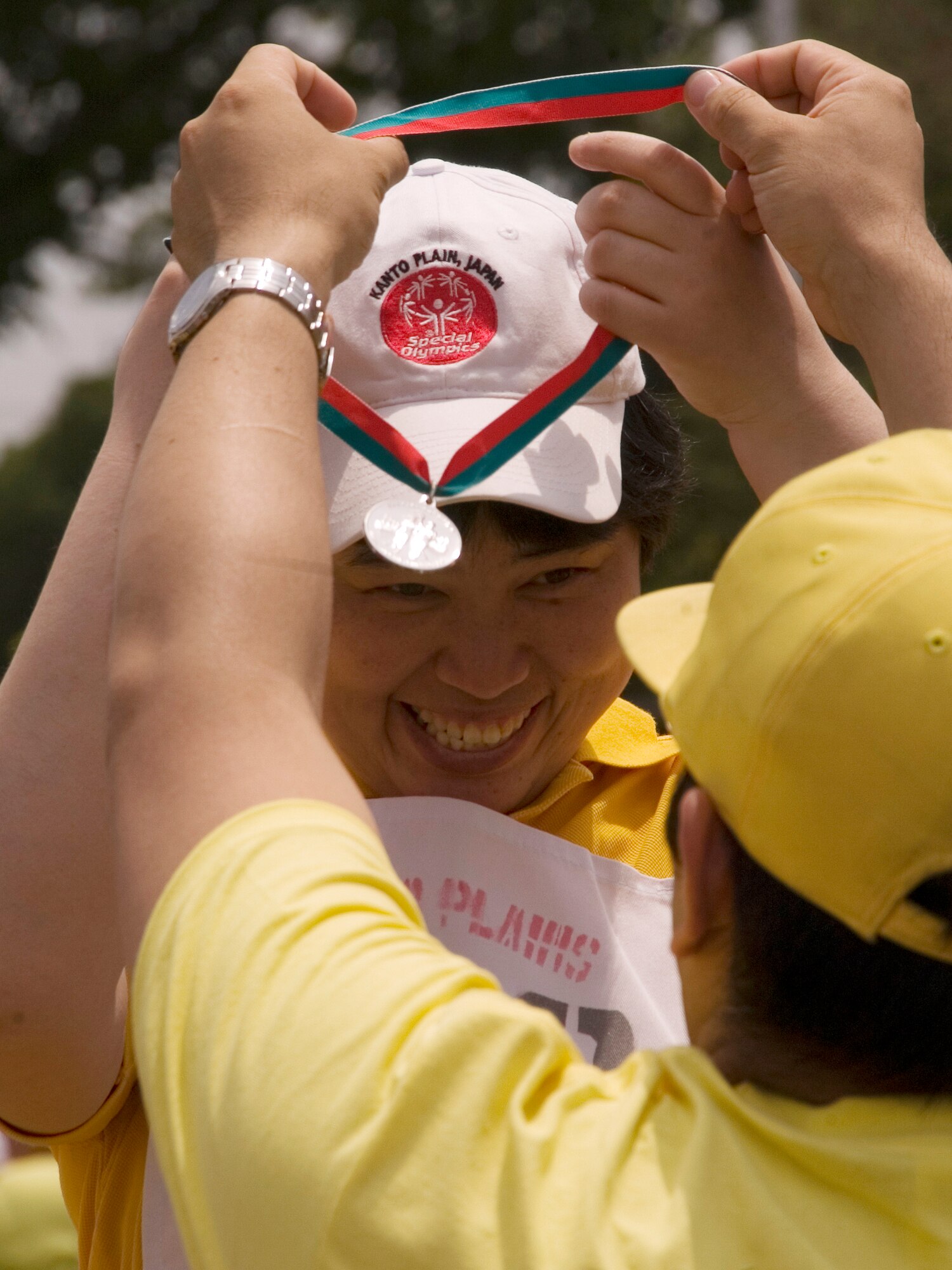 YOKOTA AIR BASE, Japan -- An athlete celebrates winning a medal in the standing long jump competition May 23 during the 30th Annual Kanto Plain Special Olympics at Yokota's Bonk Field. More than 100 athletes from eight local schools competed in events ranging from the standing long jump and 50-meter dash to bowling and swimming. More than 300 volunteers from U.S. military installations and members of the Japanese Self Defense Forces also took part in the event. (U.S. Air Force photo/Master Sgt. Matt Summers)