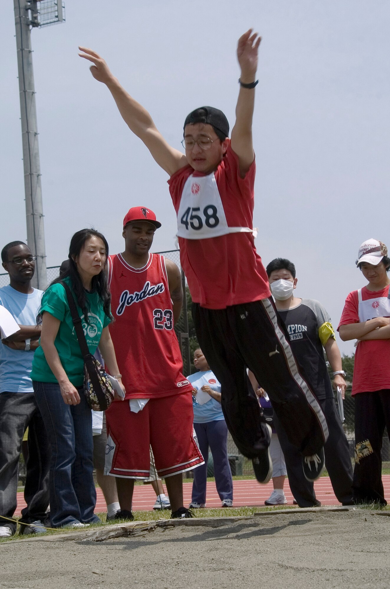 YOKOTA AIR BASE, Japan -- Daiju Matsui from the Dai Ni Sakura no Sono school in Nishi Tokyo spreads his wings for flight in the standing long-jump competition May 23 during the 30th Annual Kanto Plain Special Olympics at Yokota's Bonk Field. More than 100 athletes from eight local schools competed in events ranging from the standing long jump and 50-meter dash to bowling and swimming. More than 300 volunteers from U.S. military installations and members of the Japanese Self Defense Forces also took part in the event. (U.S. Air Force photo/Master Sgt. Matt Summers)