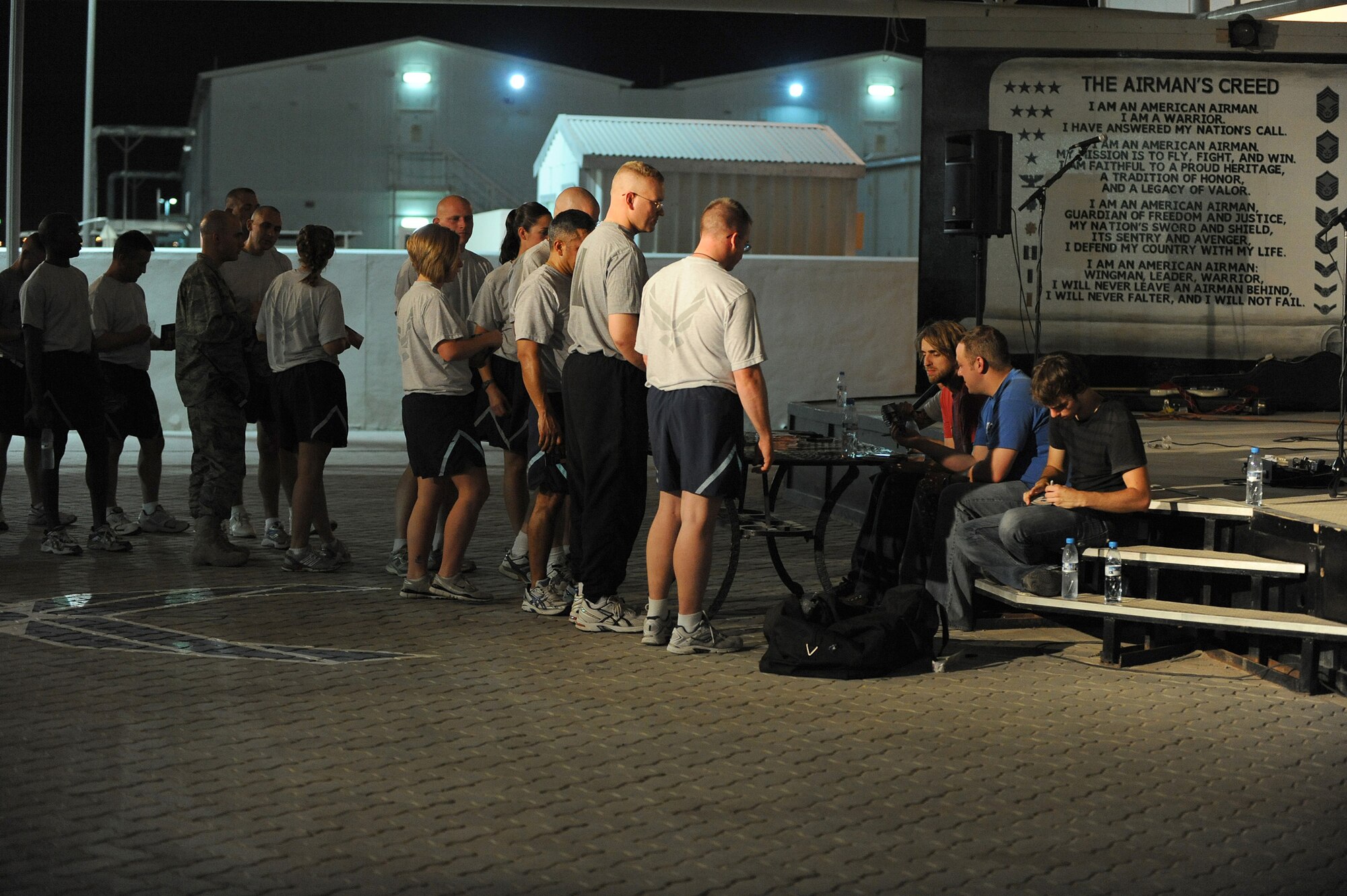SOUTHWEST ASIA - Airmen and Soldiers of the 380th Air Expeditionary Wing stand in line to get CD's and autographs from The Stellas after their performance, May 17 at an undisclosed location in Southwest Asia. The band performed at several locations throughout Southwest Asia as part of an Armed Forces Entertainment tour. (U.S. Air Force photo by Senior Airman Brian J. Ellis) (Released)