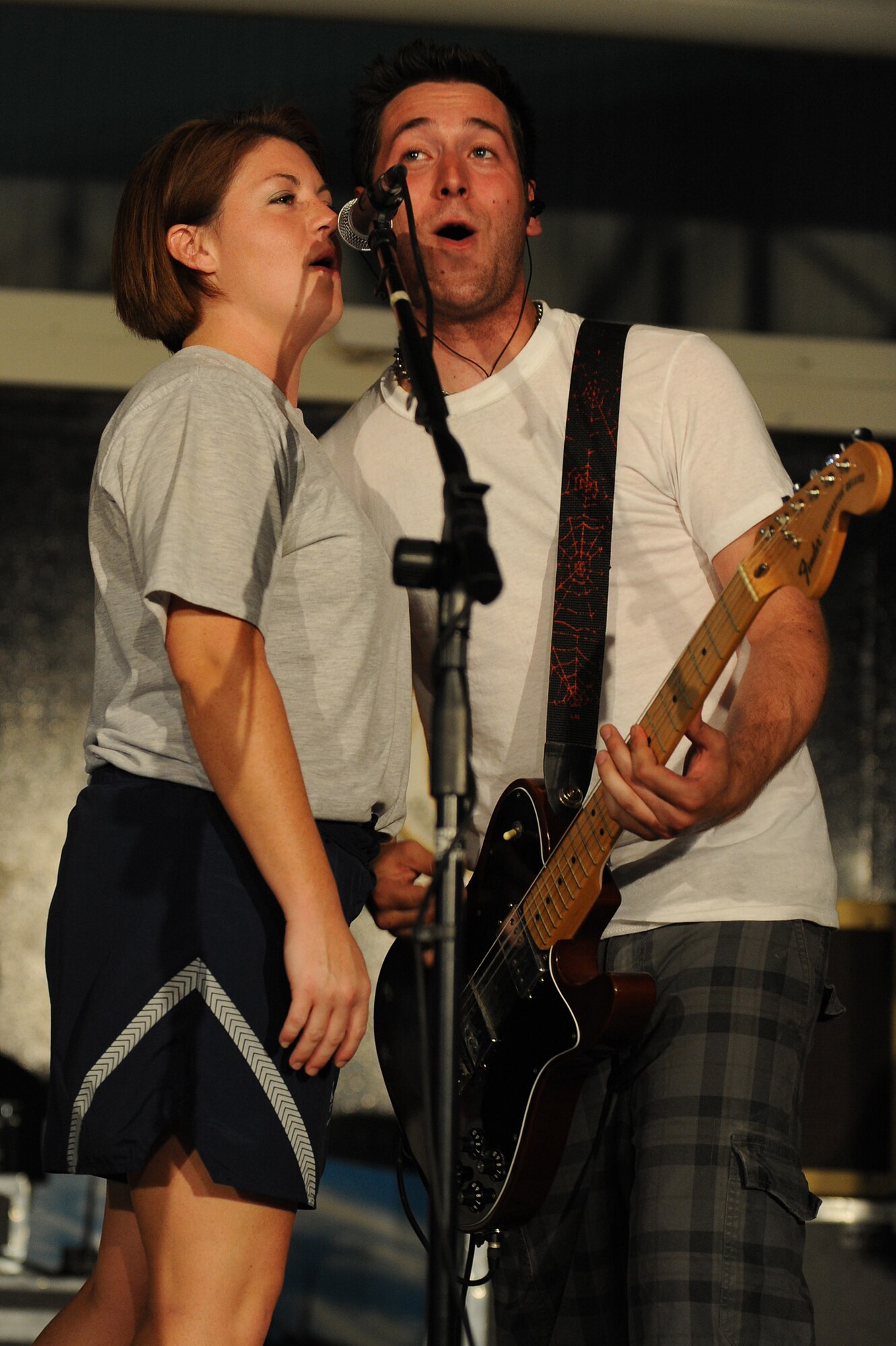 SOUTHWEST ASIA - Senior Airman Rachelle Belflower, 380th Expeditionary Force Support Squadron, sings onstage with Shaun McFall of the band The Stellas, May 17 at an undisclosed location in Southwest Asia. The band performed at several locations throughout Southwest Asia as part of an Armed Forces Entertainment tour. (U.S. Air Force photo by Senior Airman Brian J. Ellis) (Released)