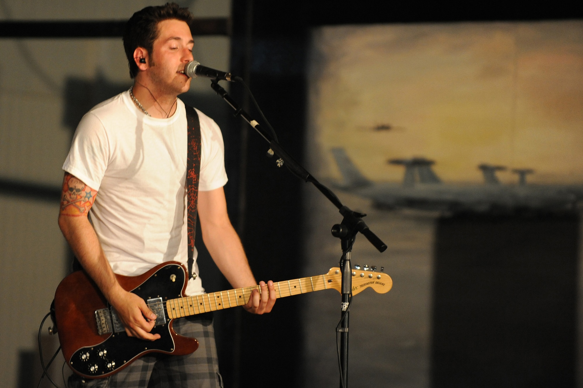 SOUTHWEST ASIA - Shaun McFall, guitar and vocals for The Stellas, performs for Airman and Soldiers of the 380th Air Expeditionary Wing, May 17 at an undisclosed location in Southwest Asia. The band performed at several locations throughout Southwest Asia as part of an Armed Forces Entertainment tour. (U.S. Air Force photo by Senior Airman Brian J. Ellis) (Released)