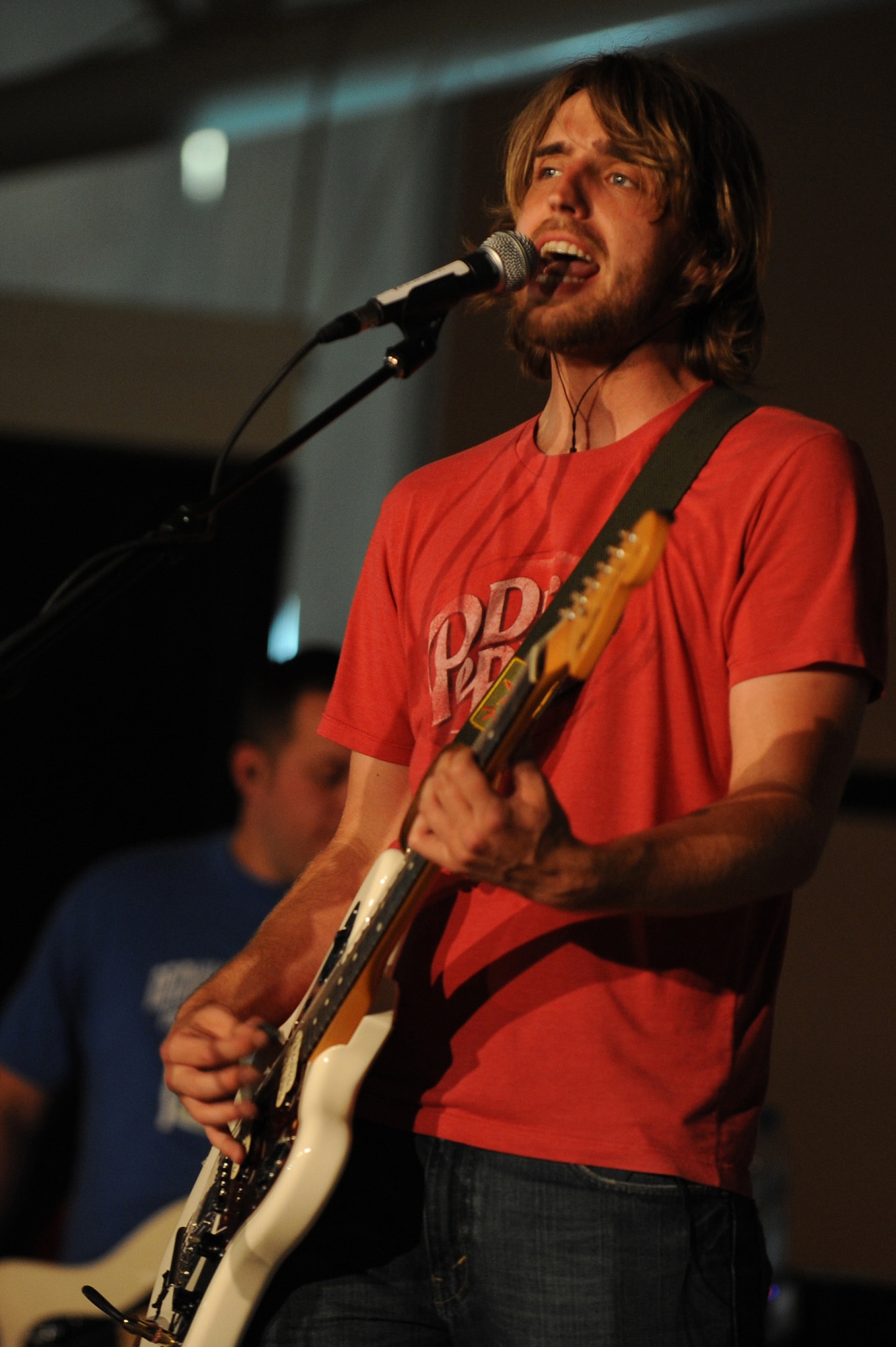 SOUTHWEST ASIA - Adam Middleton, lead singer of The Stellas, rocks out in front of Airman and Soldiers of the 380th Air Expeditionary Wing, May 17 at an undisclosed location in Southwest Asia. The band performed at several locations throughout Southwest Asia as part of an Armed Forces Entertainment tour. (U.S. Air Force photo by Senior Airman Brian J. Ellis) (Released)