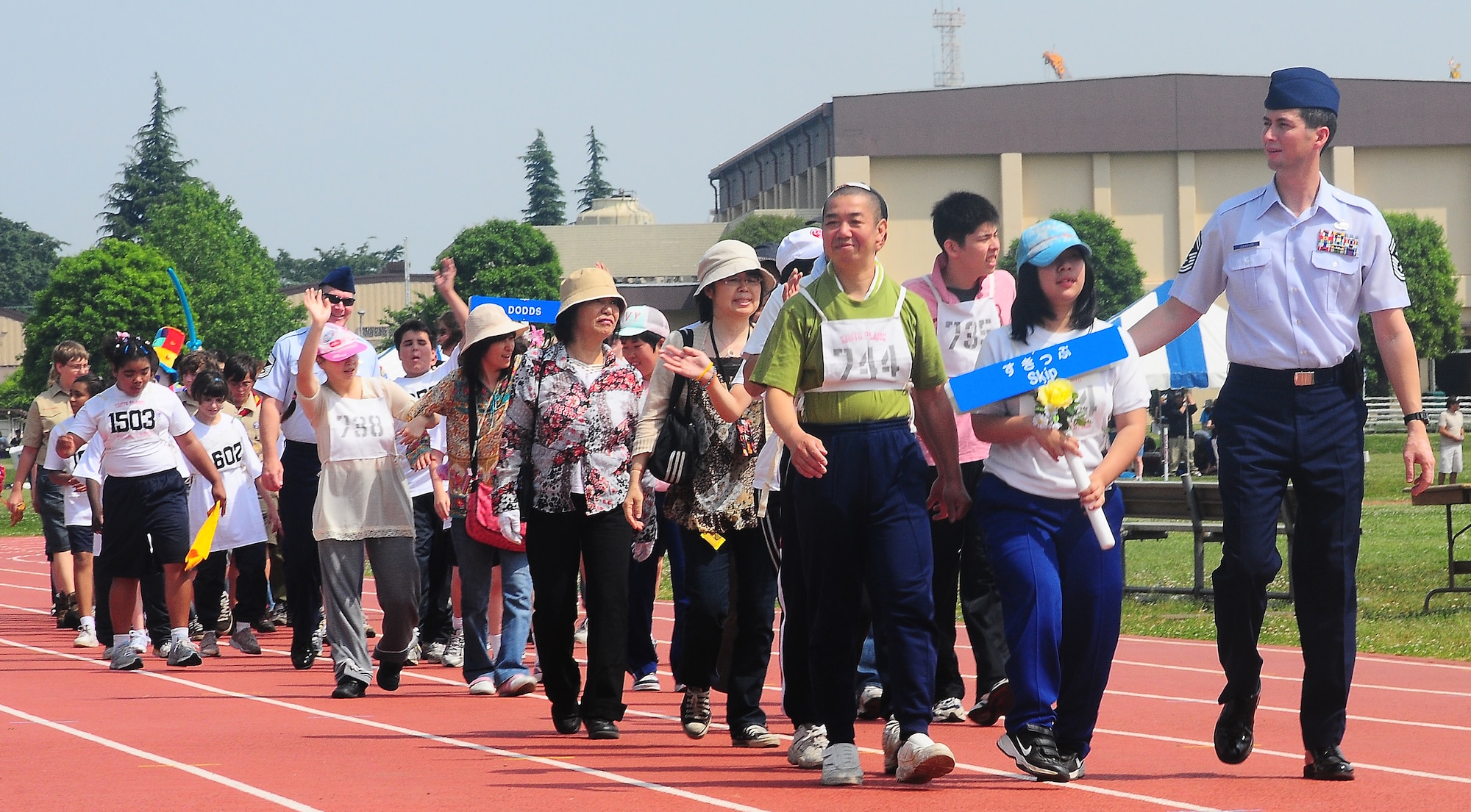 YOKOTA AIR BASE, Japan -- Senior Master Sgt. Tom Johnson, 374th Maintenance Squadron first sergeant, escorts athletes from the Skip school in Musashi-Murayama during the Parade of Hope May 23 at the opening ceremonies of the 30th Annual Kanto Plain Special Olympics at Yokota's Bonk Field. More than 100 athletes from eight local schools competed in events ranging from the standing long jump and 50-meter dash to bowling and swimming. More than 300 volunteers from U.S. military installations and members of the Japanese Self Defense Forces also took part in the event. (U.S. Air Force photo/Airman Sean Martin)


