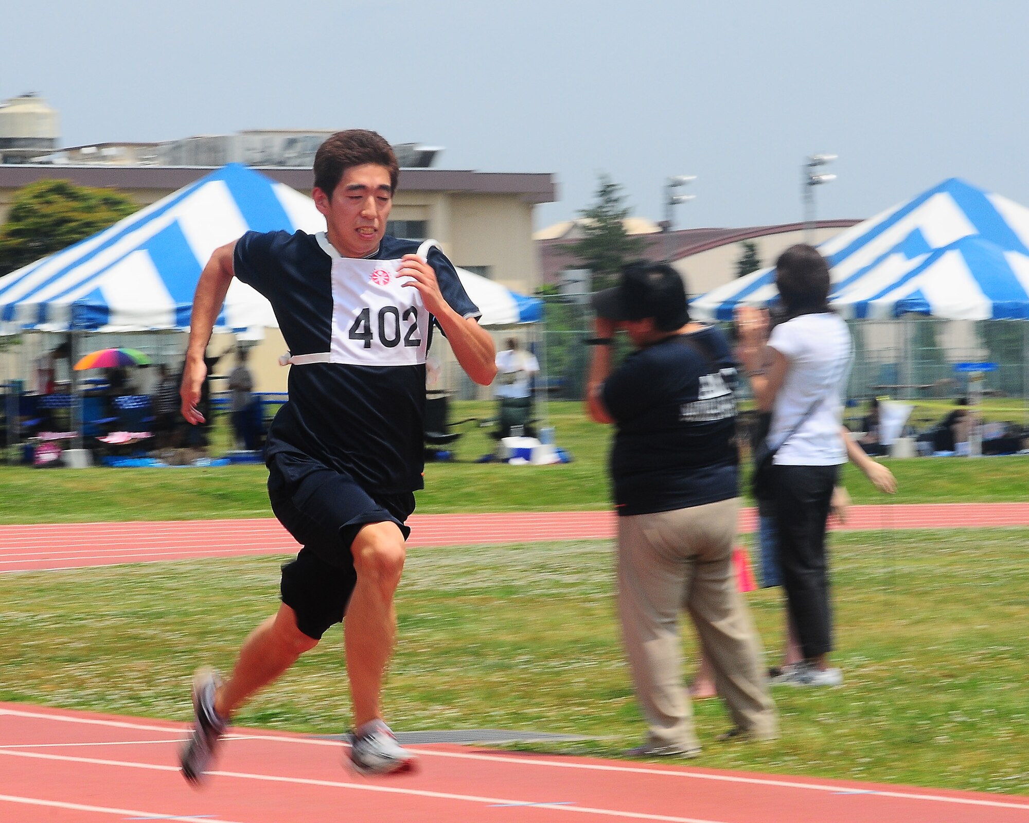 YOKOTA AIR BASE, Japan --  Koichi Yamada, from AMC Sports Club, heads down the homestretch of the 200-meter dash May 23 during the 30th Annual Kanto Plain Special Olympics at Yokota's Bonk Field. More than 100 athletes from eight local schools competed in events ranging from the standing long jump and 50-meter dash to bowling and swimming. More than 300 volunteers from U.S. military installations and members of the Japanese Self Defense Forces also took part in the event. (U.S. Air Force photo/Airman Sean Martin)