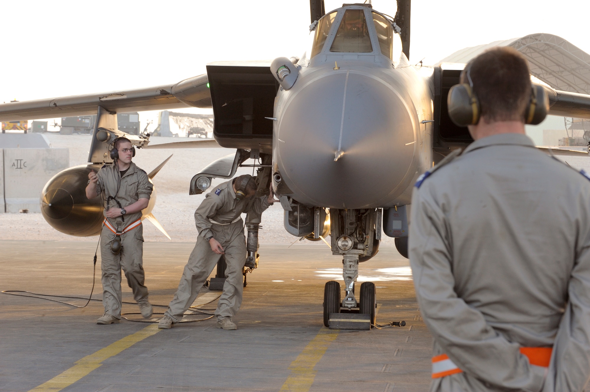 Corporal John Mercer, watches over both Senior Aircraftsman Andrew Collister and Senior Aircraftsman Sam Goodwin, all crew chiefs for the 2nd Squadron Tornado Detachment, as they finish the pre-flight on a Royal Air Force Tornado, May 25, 2009, in an undisclosed location in Southwest Asia.  Corporal Mercer performs a quality assurance roll ensuring that both SAC Collister and SAC Goodwin safely and efficiently pre-flight the aircraft.  All are deployed in Support of Operations Iraqi and Enduring Freedom and Combined Joint Task Force - Horn of Africa.  (U.S. Air Force Photo by Staff Sgt. Joshua Garcia/released)