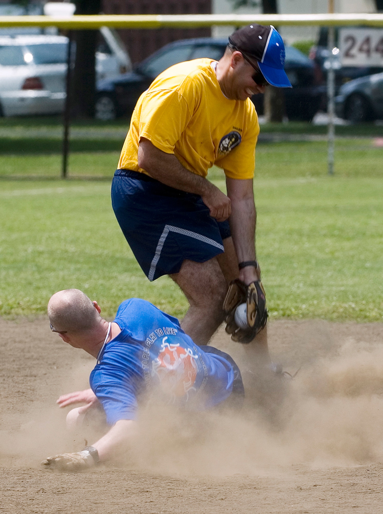 YOKOTA AIR BASE, Japan -- Chief Master Sgt. Allen Mullinex, 374th Maintenance Group, slides under the tag of Lt. Col. Anthony Maisonet, 374th Security Forces Squadron, during the Chiefs vs. Eagles softball game May 21 at Yokota's Safety and Sports Day. The Chiefs squeeked past the Eagles 3-2. Safety and sports day helped the base kickoff the 101 Critical Days of Summer, which runs through Labor Day. (U.S. Air Force photo/Master Sgt. Matt Summers)