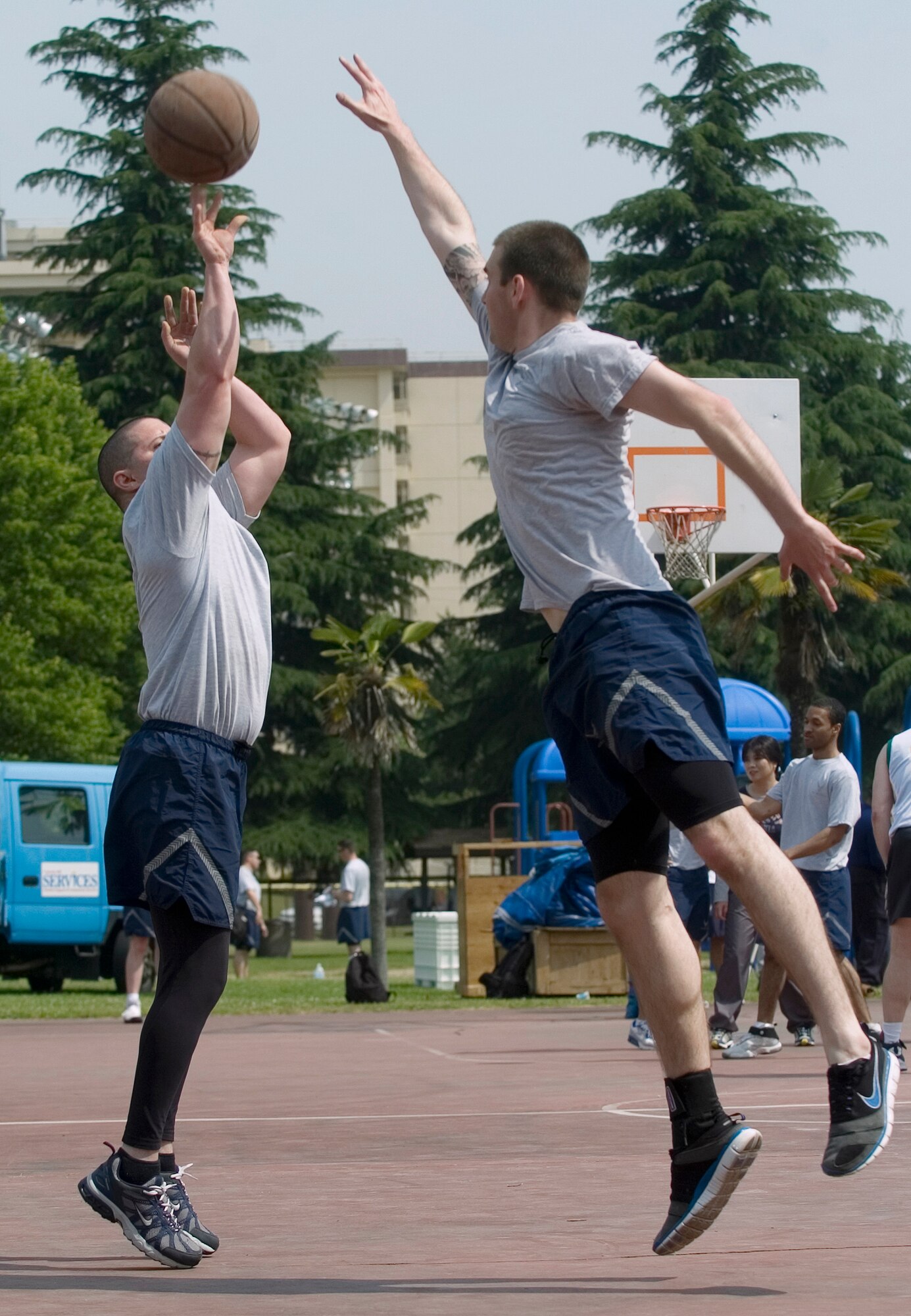 YOKOTA AIR BASE, Japan -- Airman 1st Class Devin Doskey, 374th Airlift Wing, tries to block a shot against 5th Air Force during the 3-on-3 basketball challenge May 21 at Yokota's Safety and Sports Day. The 374th Civil Engineer Squadron won the basketball competition, while the 374th Comptroller Squadron and 374th Logistics Readiness Squadron came in second and third respectively. Safety and sports day helped the base kickoff the 101 Critical Days of Summer, which runs through Labor Day. (U.S. Air Force photo/Master Sgt. Matt Summers)