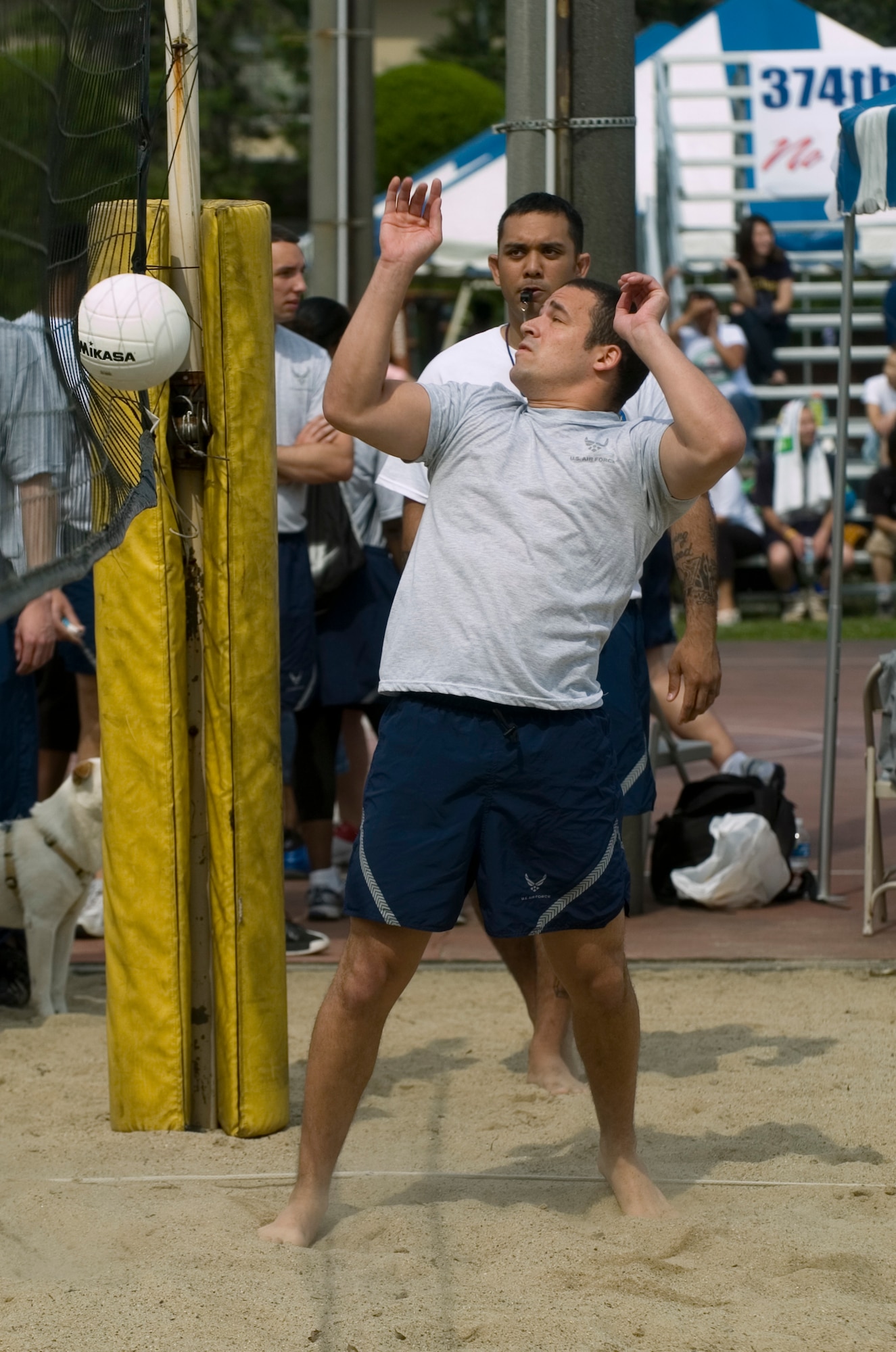 YOKOTA AIR BASE, Japan -- A setter watches his teammate's pass go into the net May 21 at Yokota's Safety and Sports Day. The 730th Air Mobility Squadron won the sand volleyball competition, while the 374th Operations Support Squadron and 374th Contracting Squadron, came in second and third respectively. Safety and sports day helped the base kickoff the 101 Critical Days of Summer, which runs through Labor Day. (U.S. Air Force photo/Master Sgt. Matt Summers)