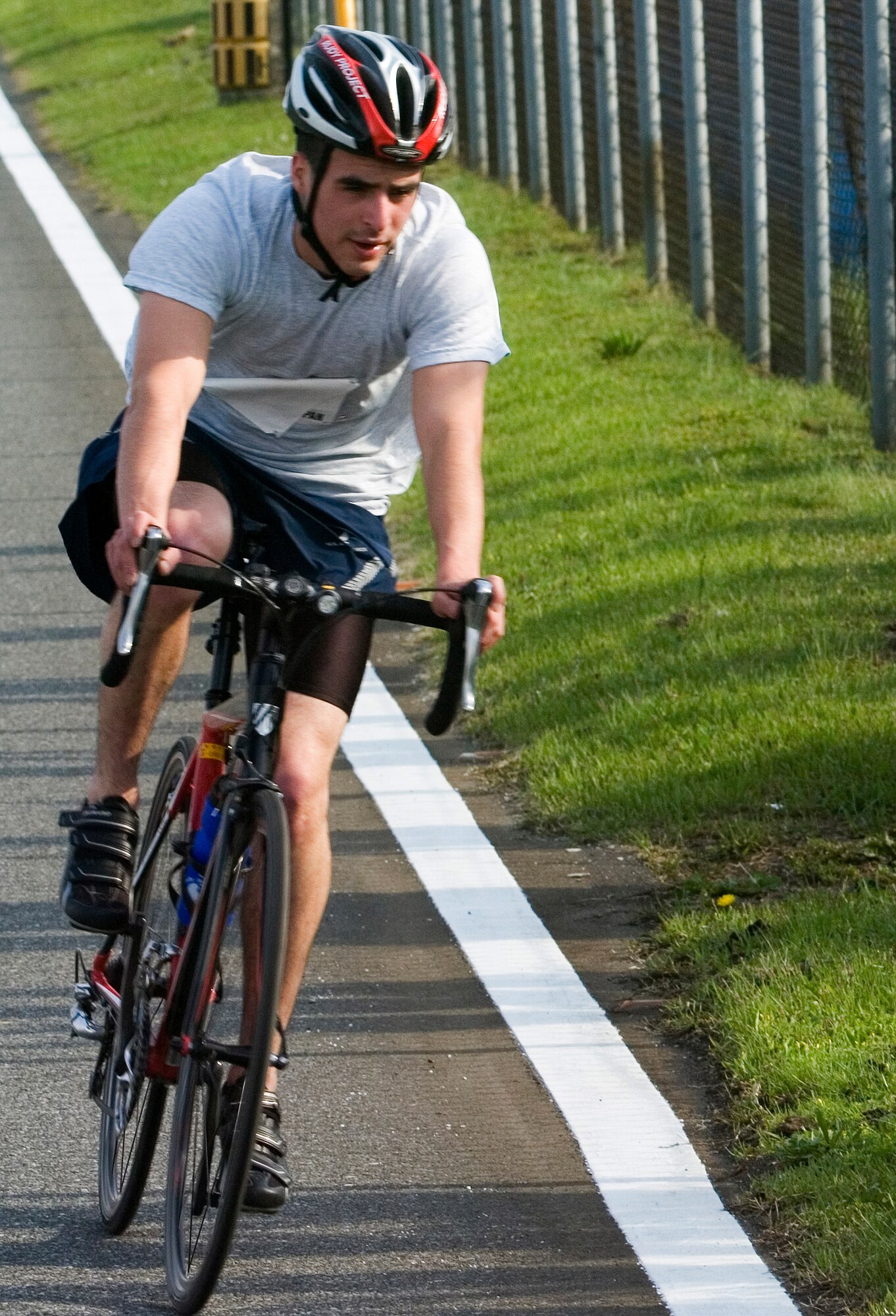 YOKOTA AIR BASE, Japan -- Airman 1st Class Blake Navarrette, 374th Medical Operations Squadron, nears the finish of the bike portion of the Samurai Challenge triathlon May 21 during Yokota's Safety and Sports Day. The triathletes completed a 400-meter swim, 10K bike course and a 3-mile run. Capt. Nathan Frost, 5th Air Force, came in first in a time of 44 minutes, 20 seconds. Airman Navarrette finished second and Lora Kerr came in third. Safety and sports day helped the base kickoff the 101 Critical Days of Summer, which runs through Labor Day. (U.S. Air Force photo/Master Sgt. Matt Summers)