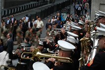 Marines from Special Purpose Marine Air Ground Task Force New York run past the Marine Forces Reserve Band at the corner of Wall Street and Broad Street, May 26. The Marines arrived May 20 as part of Fleet Week NYC 2009, and will depart May 27. (Official Marine Corp photo by Lance Cpl. Jad Sleiman)