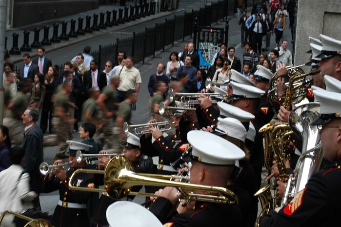Marines from Special Purpose Marine Air Ground Task Force New York run past the Marine Forces Reserve Band at the corner of Wall Street and Broad Street, May 26. The Marines arrived May 20 as part of Fleet Week NYC 2009, and will depart May 27. (Official Marine Corp photo by Lance Cpl. Jad Sleiman)