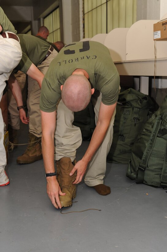 Candidates from Golf Company, Officer Candidate School, receive their uniform issue at the cash sales store aboard Marine Corps Base Quantico, Va., May 26, 2009.