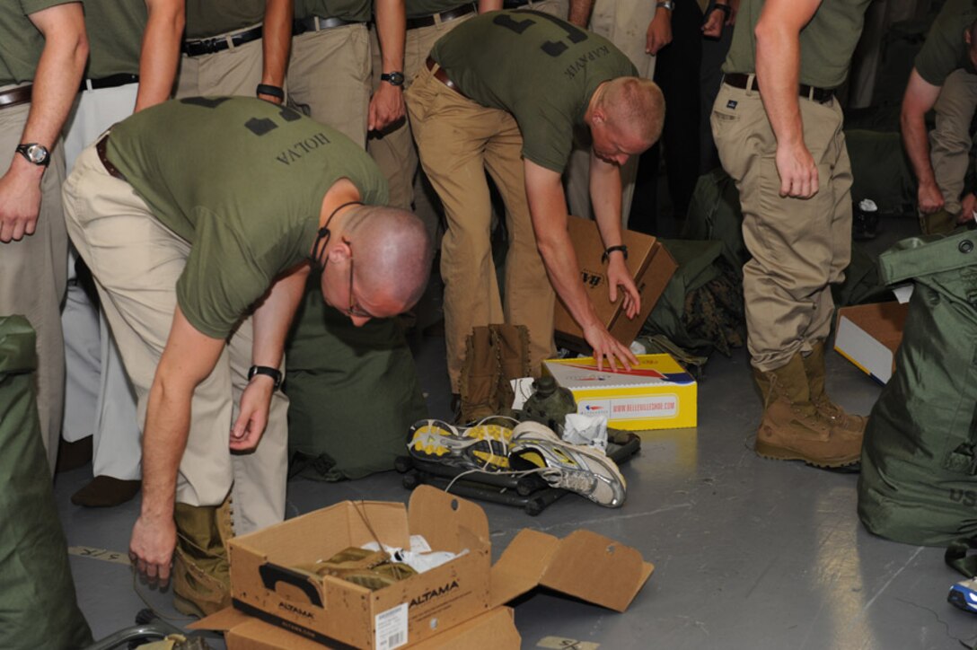 Candidates from Golf Company, Officer Candidate School, receive their uniform issue at the cash sales store aboard Marine Corps Base Quantico, Va., May 26, 2009.