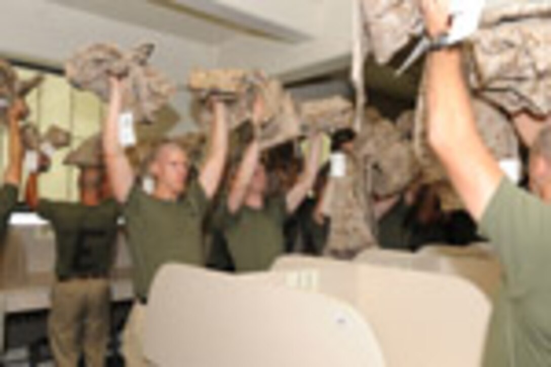 Candidates from Echo Company, Officer Candidate School, receive their uniform issue at the cash sales store aboard Marine Corps Base Quantico, Va., May 26, 2009.