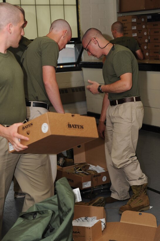 Candidates from Golf Company, Officer Candidate School, receive their uniform issue at the cash sales store aboard Marine Corps Base Quantico, Va., May 26, 2009.