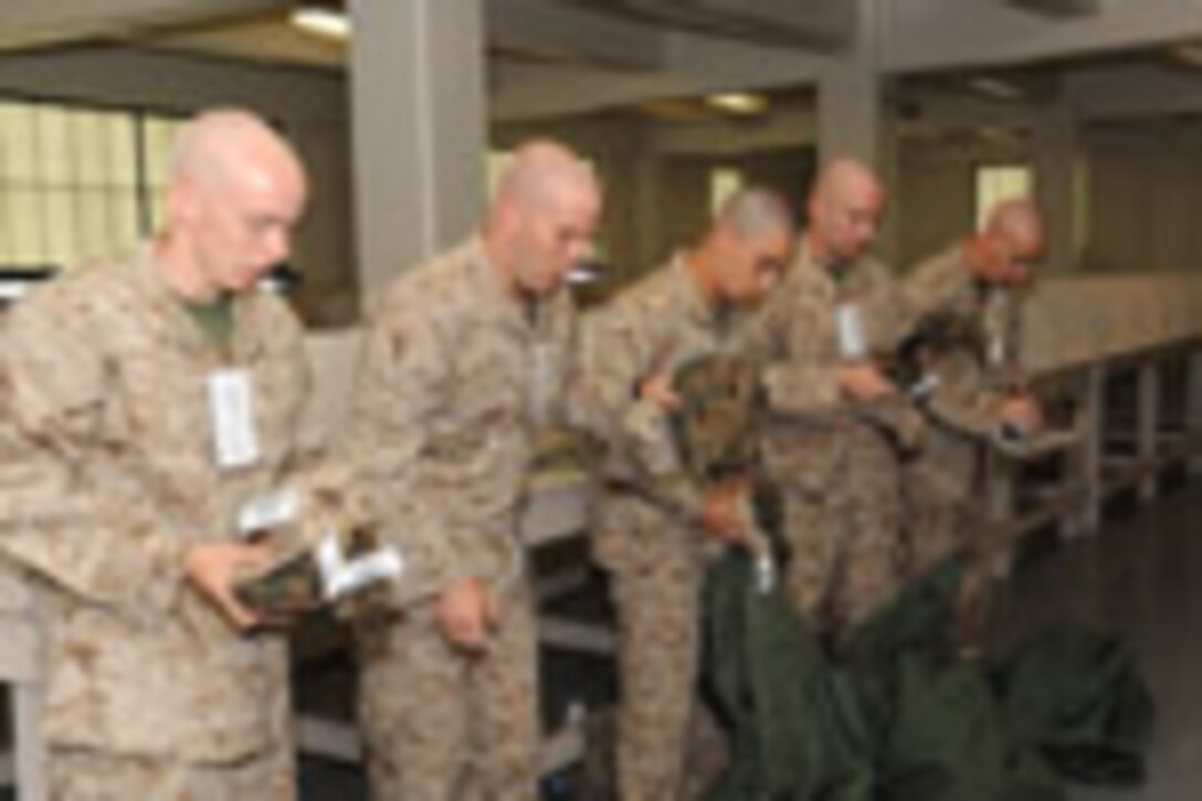 Candidates from Echo Company, Officer Candidate School, receive their uniform issue at the cash sales store aboard Marine Corps Base Quantico, Va., May 26, 2009.
