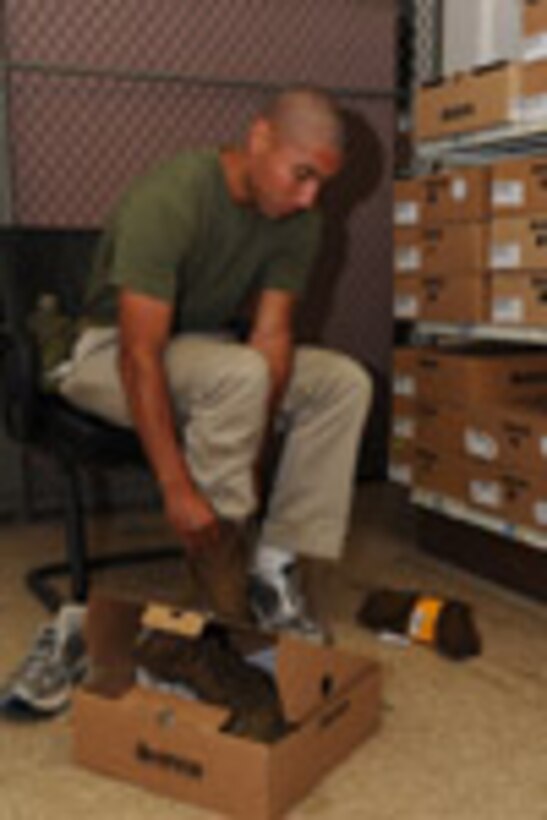 Candidates from Echo Company, Officer Candidate School, receive their uniform issue at the cash sales store aboard Marine Corps Base Quantico, Va., May 26, 2009.